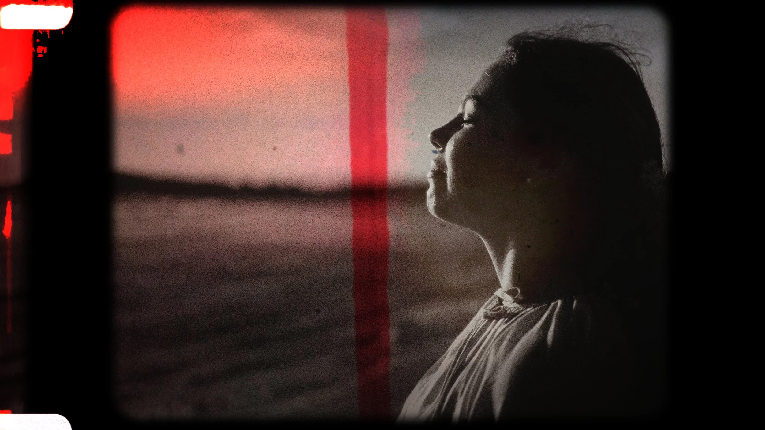 Black and white vintage film portrait of Evgenia in profile by the sea at Akrotiri, Cyprus, Red Lens Films