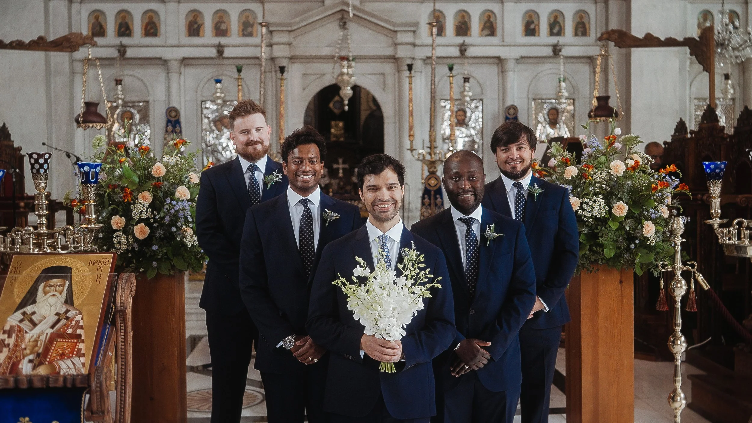 Groom and groomsmen at altar inside Ayioi Omoloyites church, Greek Orthodox wedding Nicosia Cyprus, Red Lens Films
