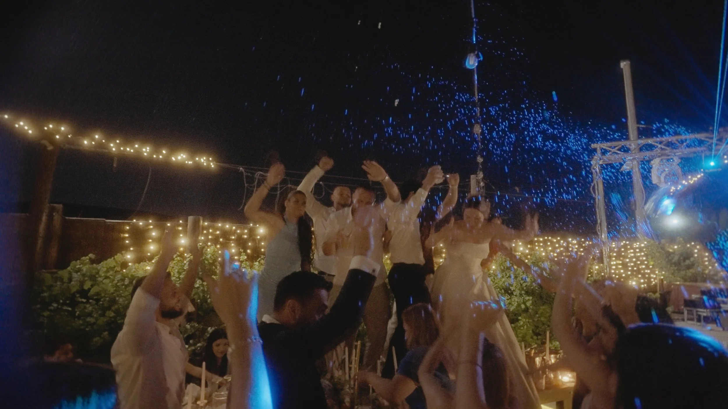 Bride and guests dancing with arms raised under falling confetti at Ktima Xristalogianni Avdellero Larnaca, Red Lens Films