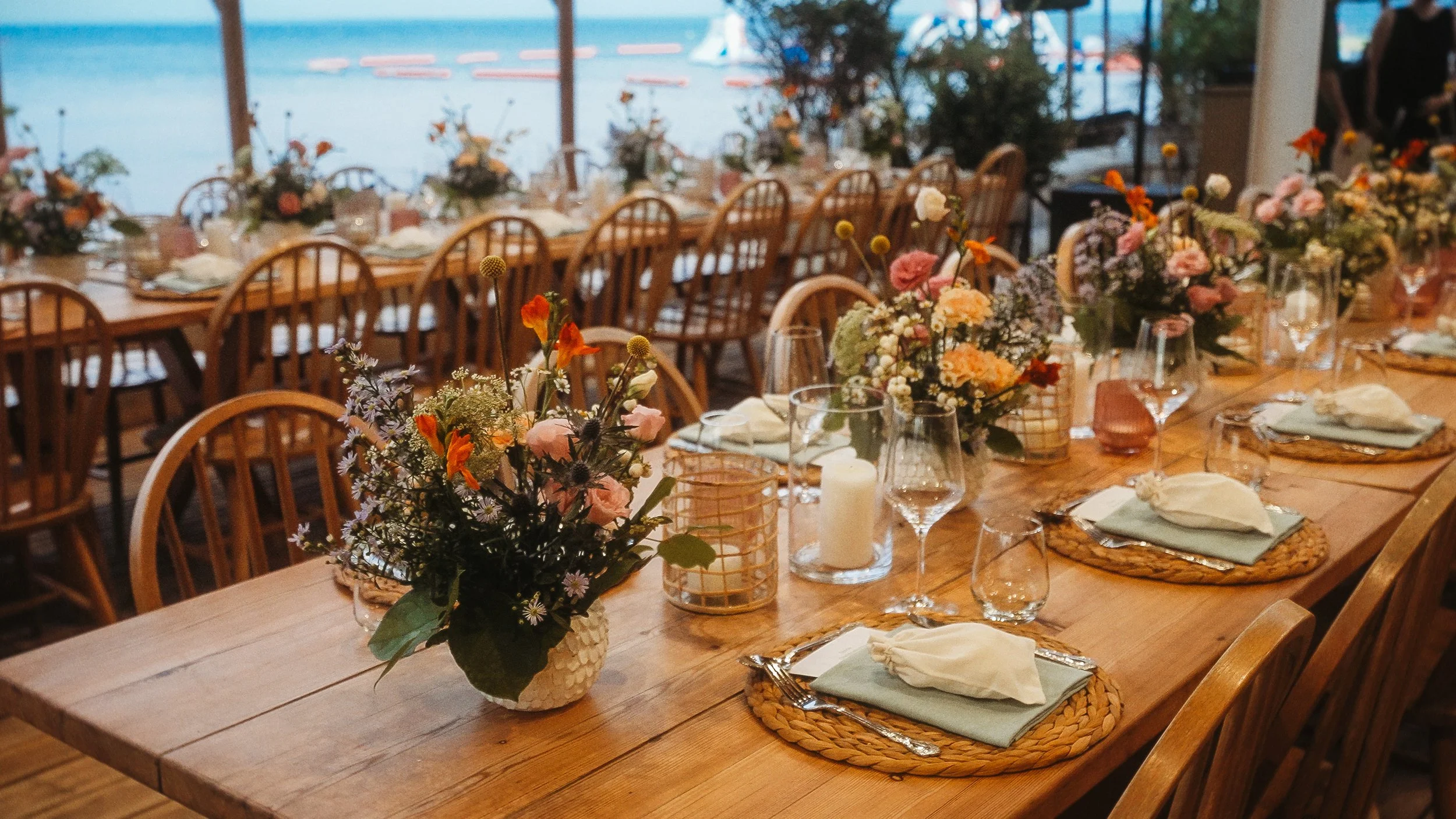 Wedding reception table with wildflower arrangements and sea view, Captain's Cabin Lady's Mile Limassol, Red Lens Films