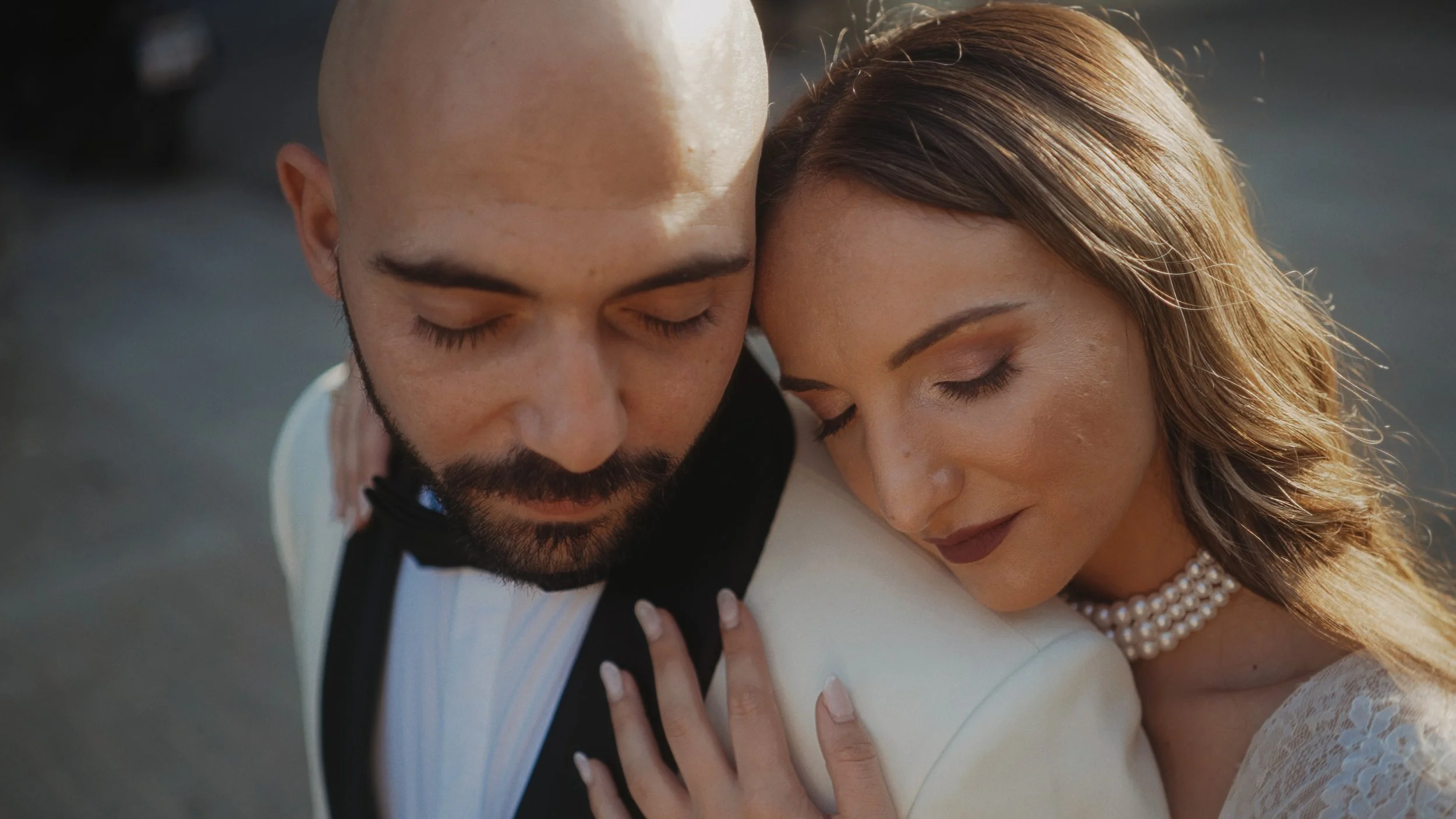 Couple in close-up embrace with eyes closed in golden hour light, old town Limassol Cyprus, Red Lens Films
