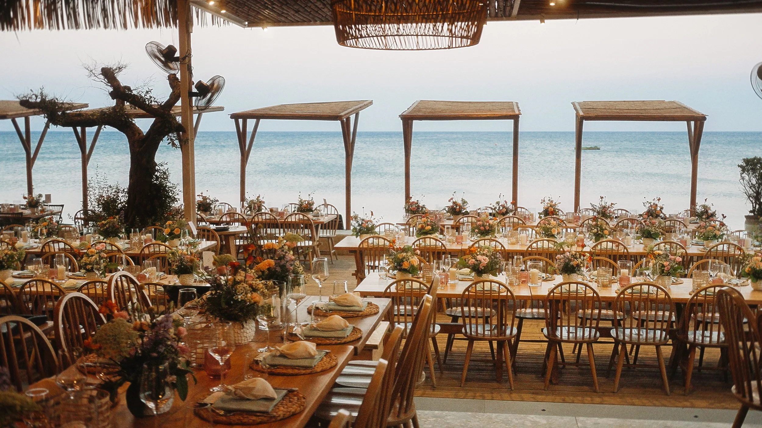 Wedding reception table with wildflower arrangements and sea view, Captain's Cabin Lady's Mile Limassol, Red Lens Films