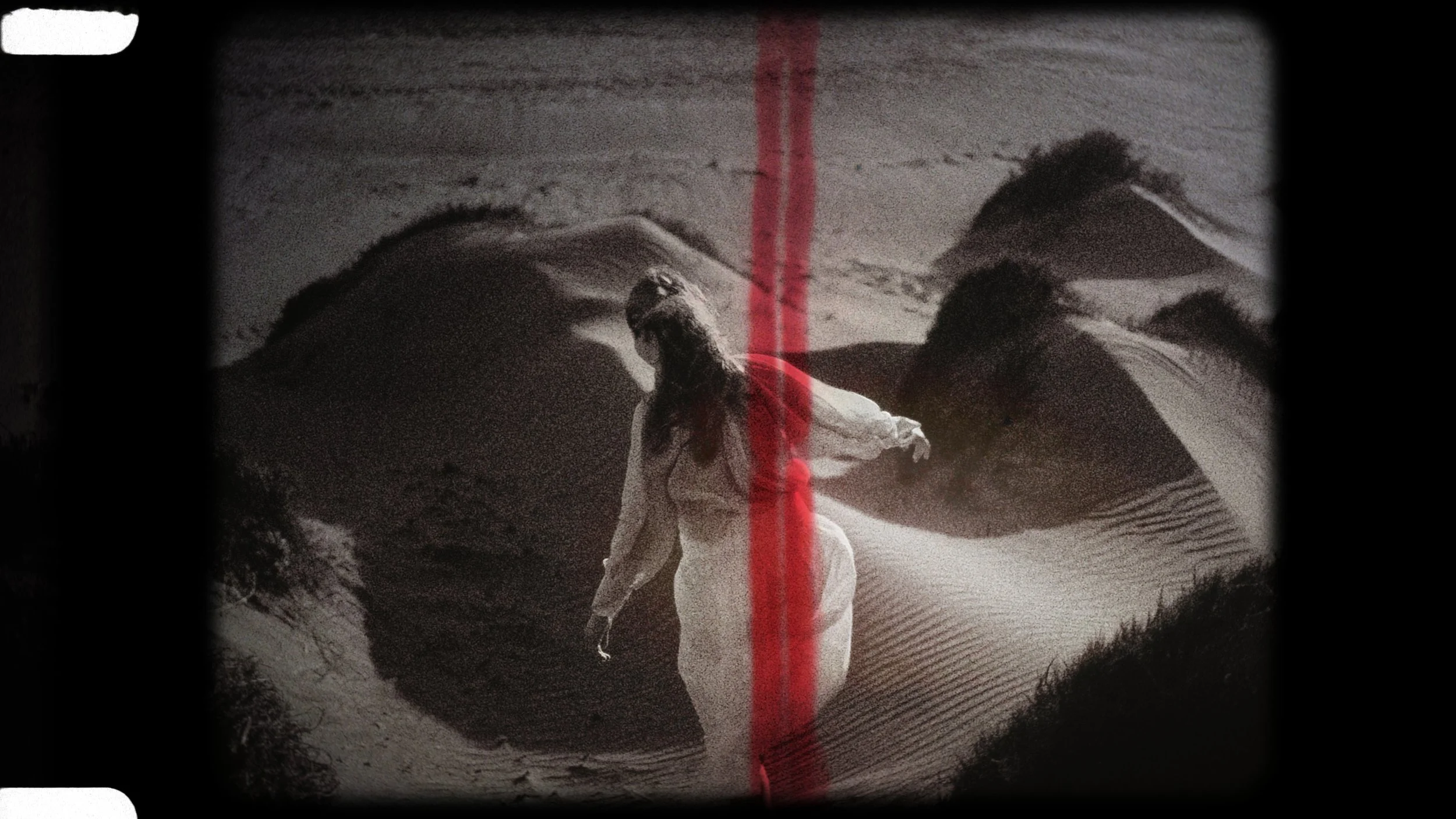 Black and white vintage film still of Evgenia walking through the Akrotiri sand dunes, Cyprus, Red Lens Films