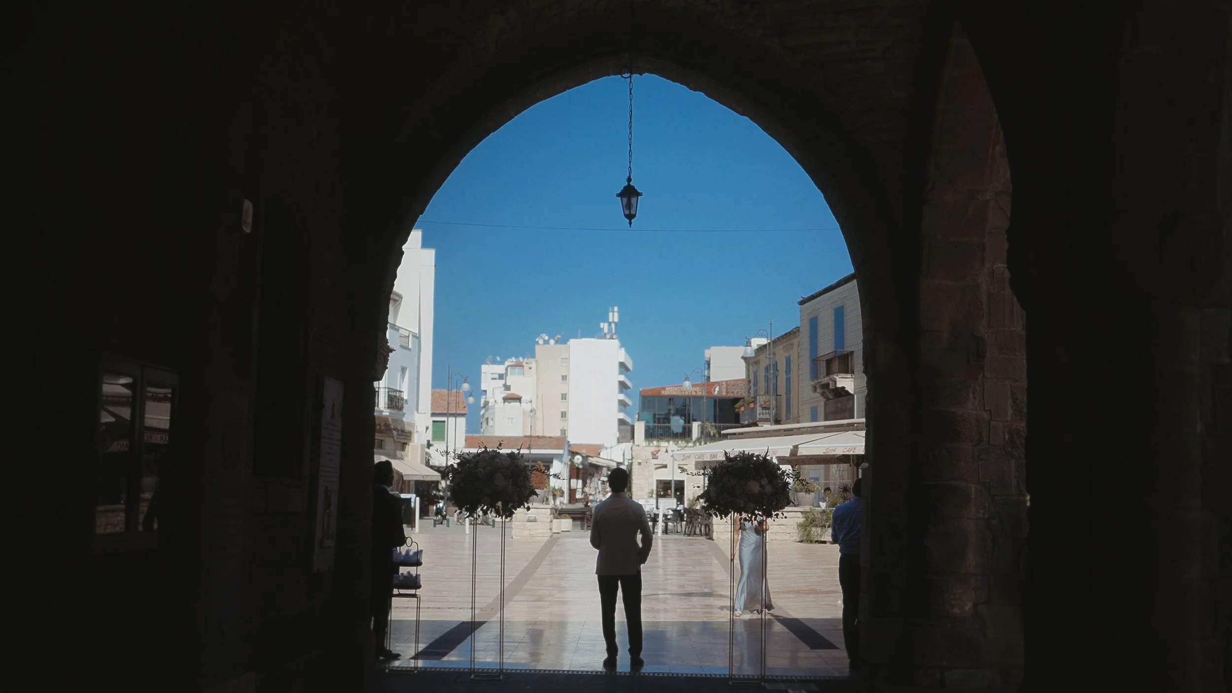 Groom Geri waiting for the bride under the stone arch of Saint Lazarus Church Larnaca, Red Lens Films