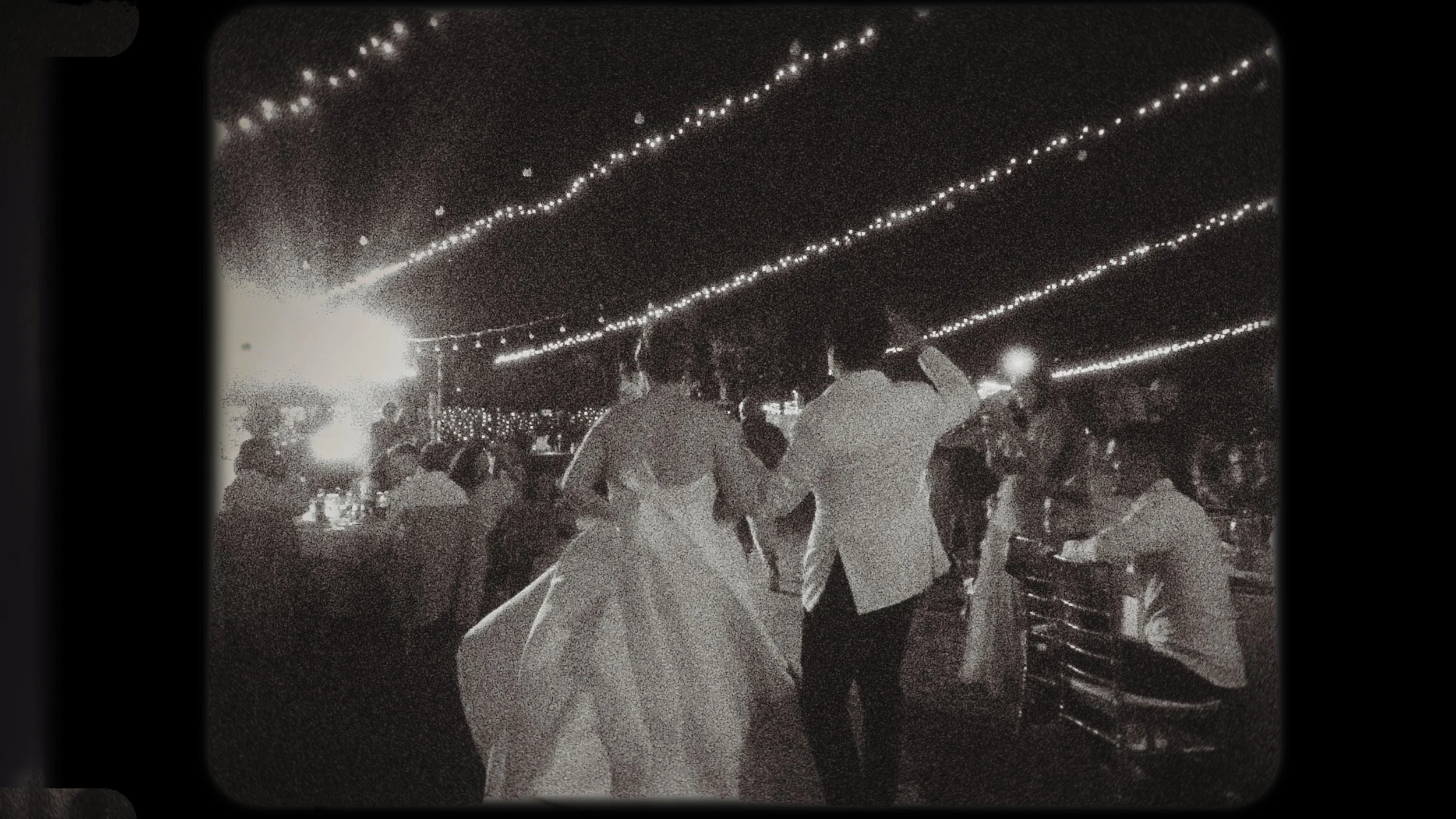 Black and white vintage film still of the couple’s grand entrance at Ktima Xristalogianni Avdellero Larnaca, Red Lens Films