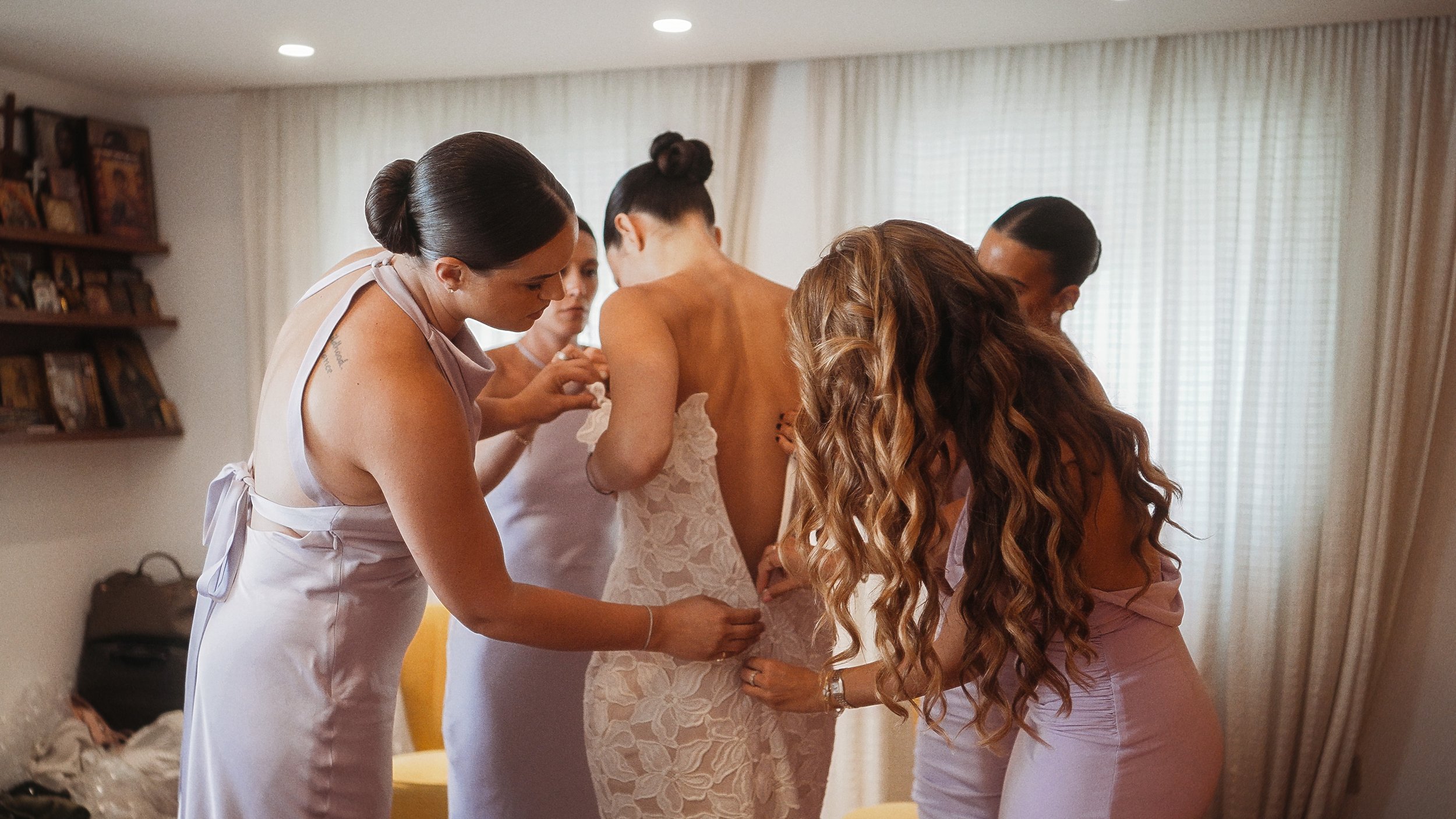 Bridesmaids helping bride into wedding dress during preparations, Nicosia Cyprus, Red Lens Films