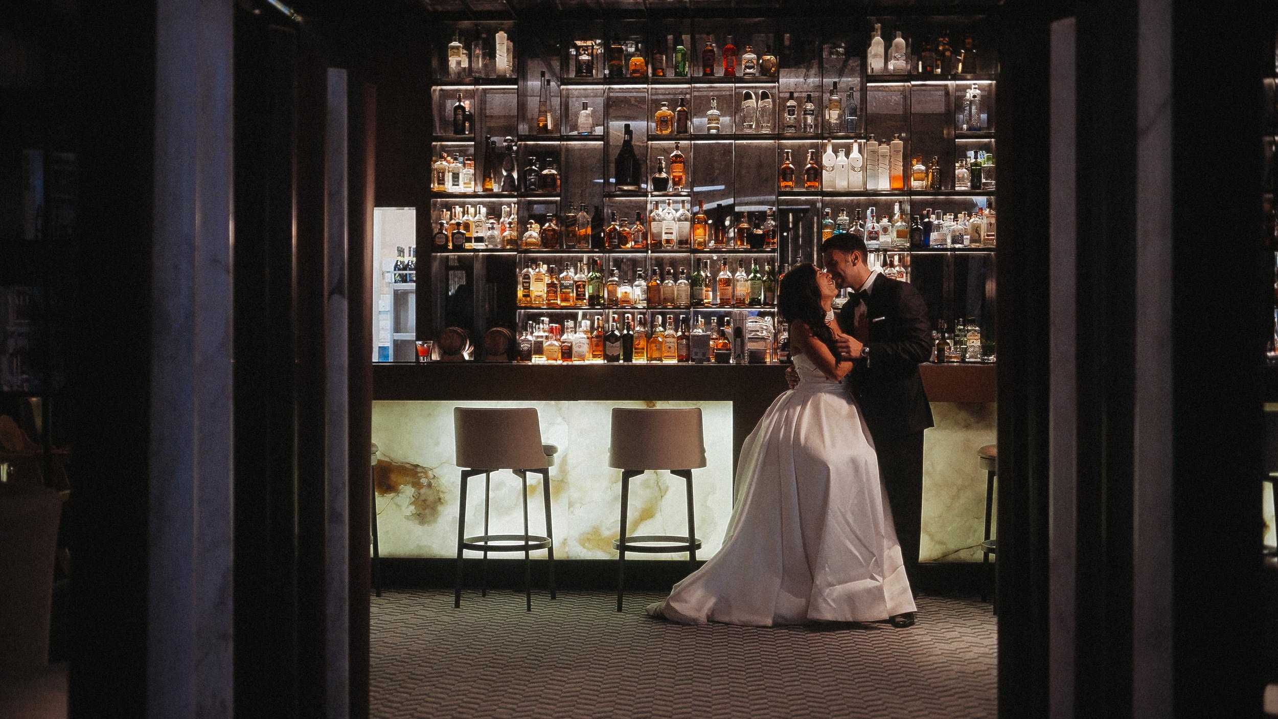 Constantinos and Christina sharing an intimate moment at the bar during their wedding reception at Amathus Beach Hotel