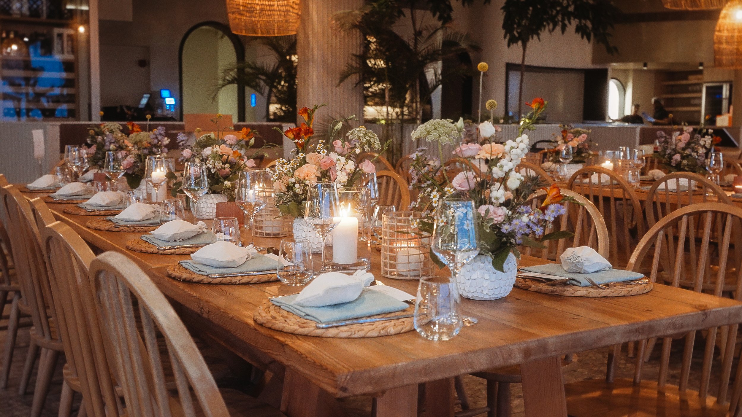 Wedding reception table with candles and wildflower arrangements at evening, Captain's Cabin Lady's Mile Limassol, Red Lens Films