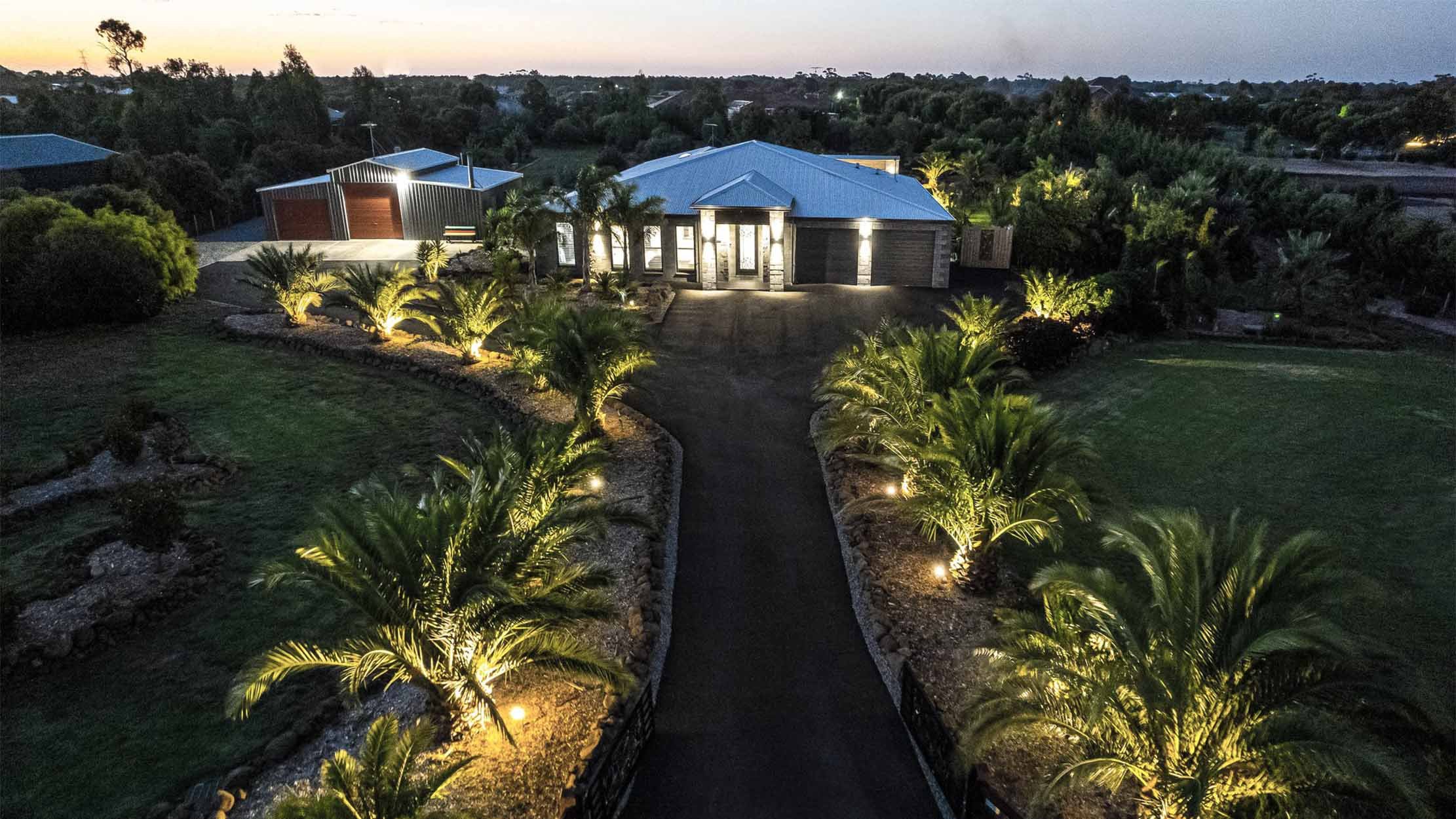 Elevated Elegance: Aerial View of Bannockburn Acreage with Palm Tree Path to Grand Entrance.