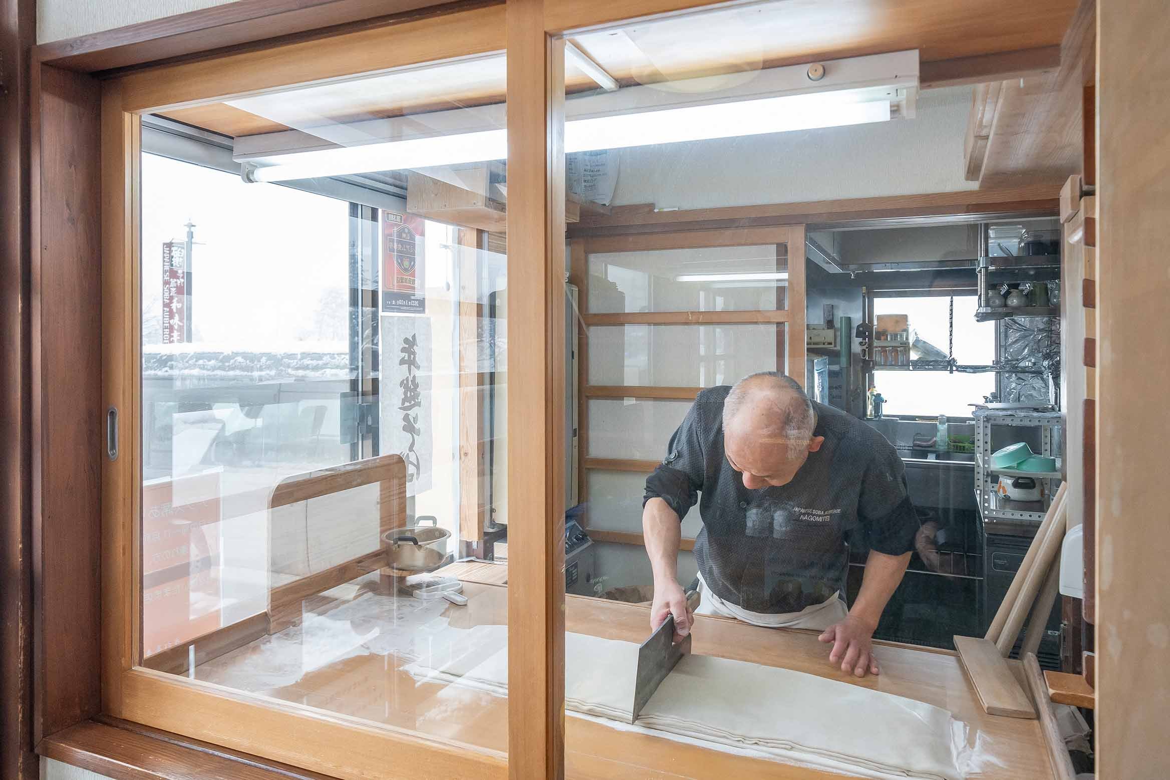 Soba Magic Unfolds: Peek into the Chef's Artistry From the Entrance.
