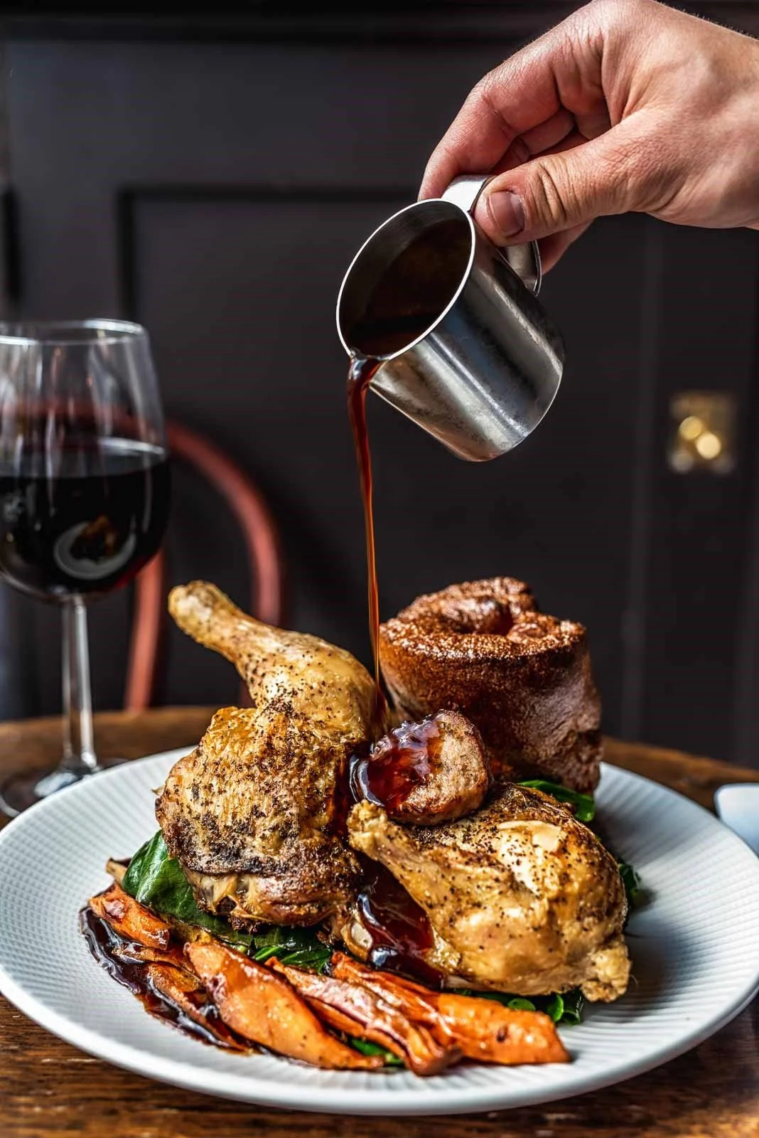 A roast chicken dinner, with carrots, Yorkshire pudding and an individual jug of rich gravy