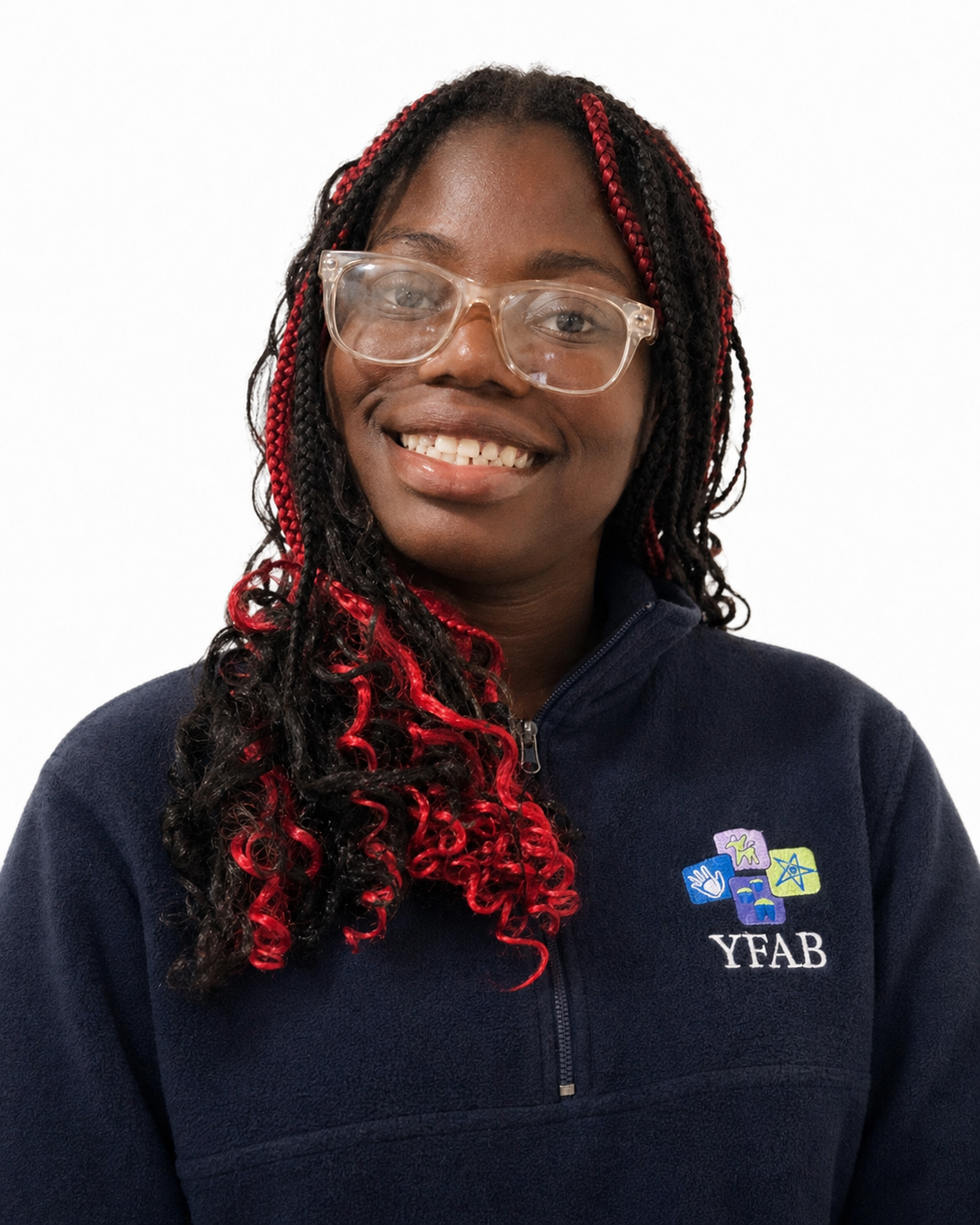 A young woman with black hair with red highlights, wearing glasses and a navy blue fleece with the YFAB logo, smiling against a plain white background.