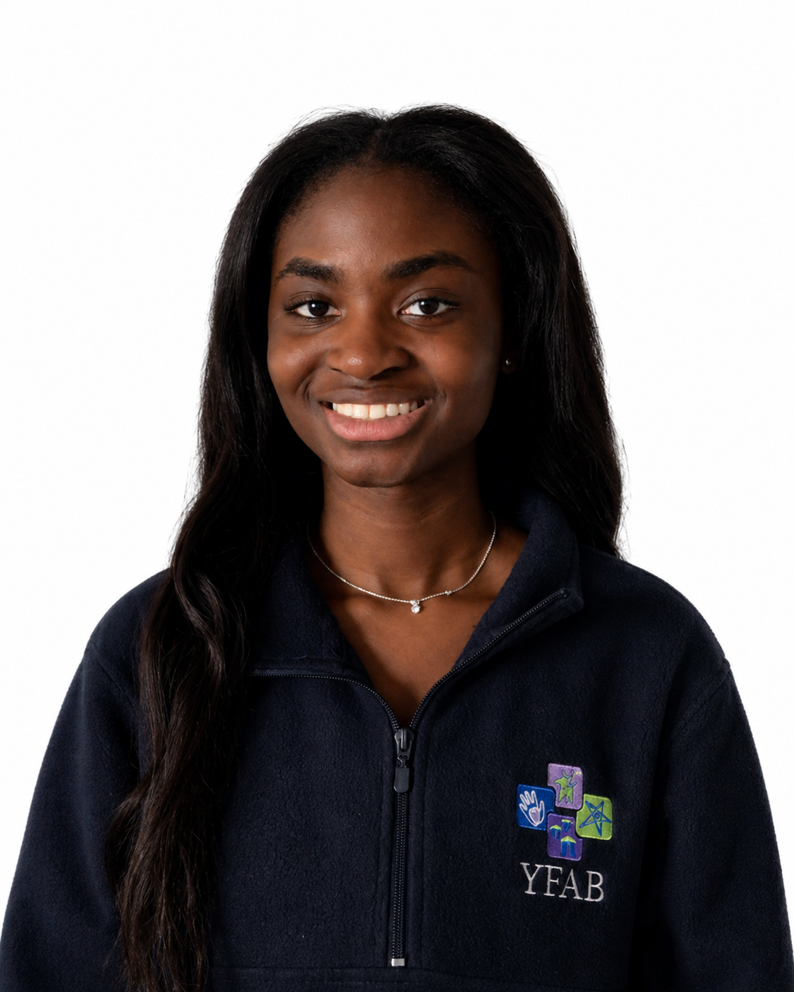 Young woman with long dark hair smiling, wearing a navy fleece jacket with 'YFAB' logo and colorful symbols, and a delicate necklace, against a white background.