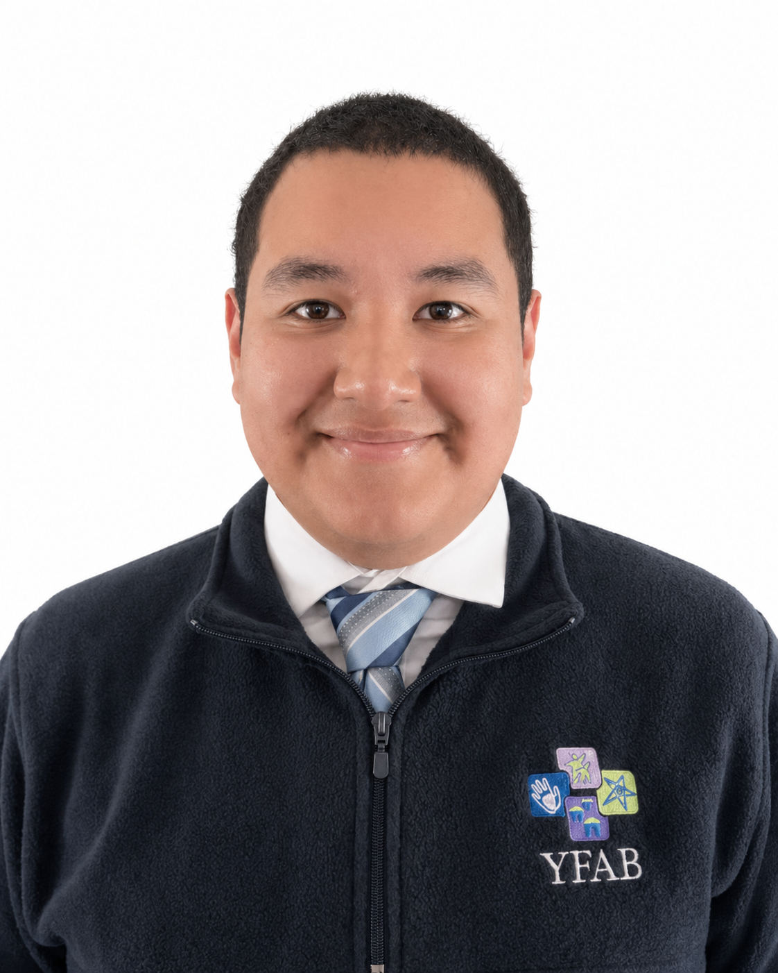 A young man with short black hair, smiling, wearing a dress shirt, tie, and a navy fleece jacket with the YFAB logo on the chest, against a white background.