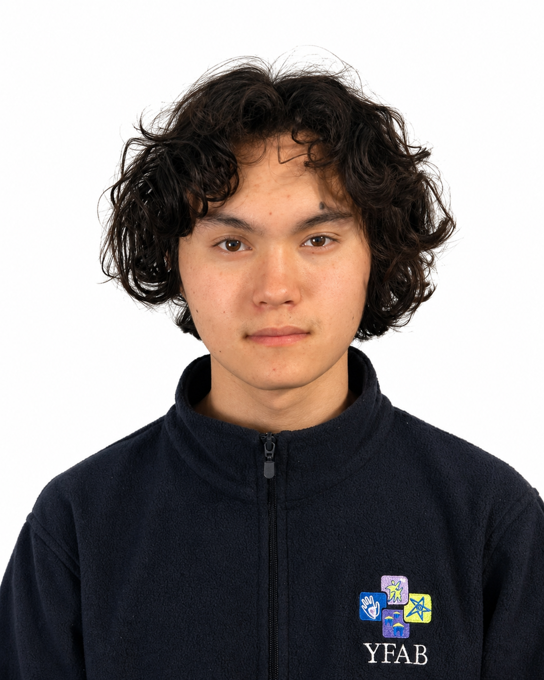 Young person with curly dark hair, wearing a black zip-up jacket with YFAB logo and colorful icons, against a white background.