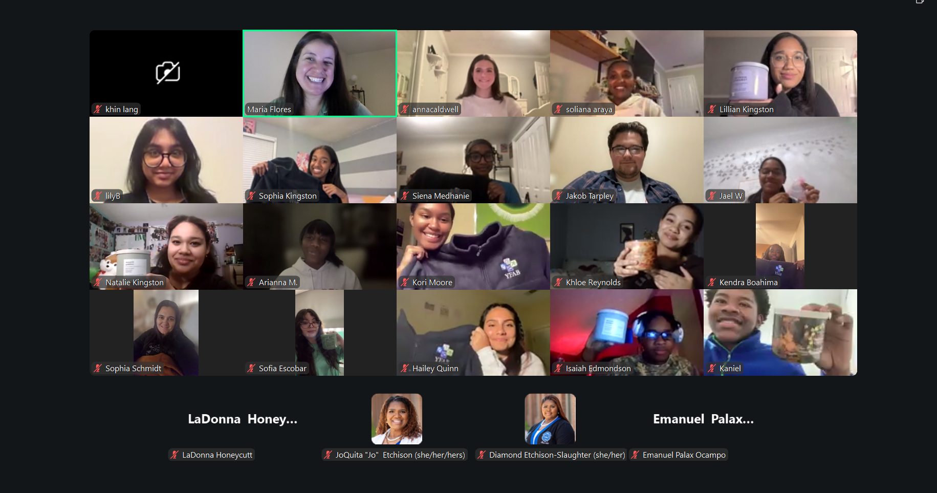 A group video call with multiple participants, mostly women, smiling and holding cups or mugs in their homes.