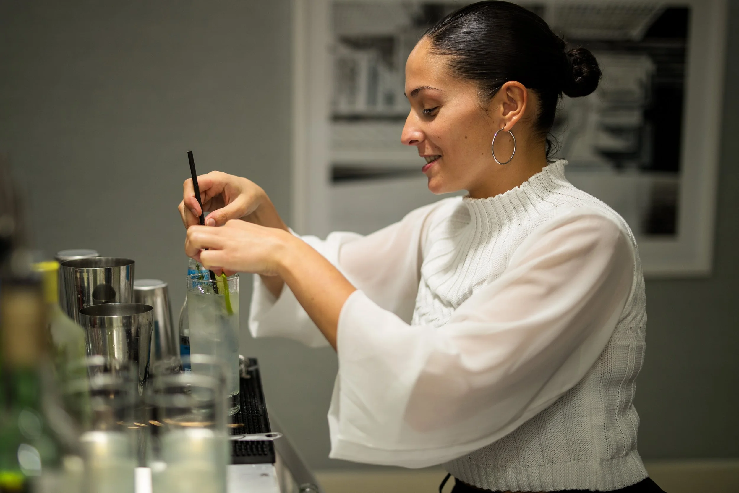 Corporate mixologist delivering warm and professional hospitality at a branded business event.
