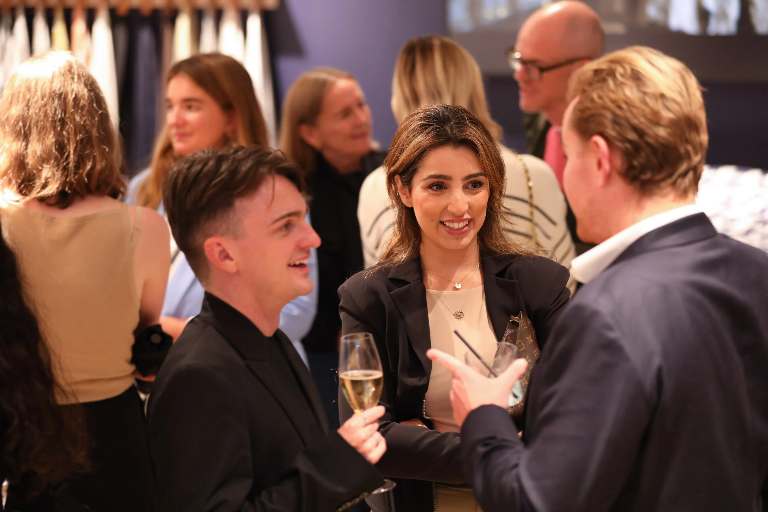Guests enjoying cocktails from bespoke cocktail bar after corporate presentation event.
