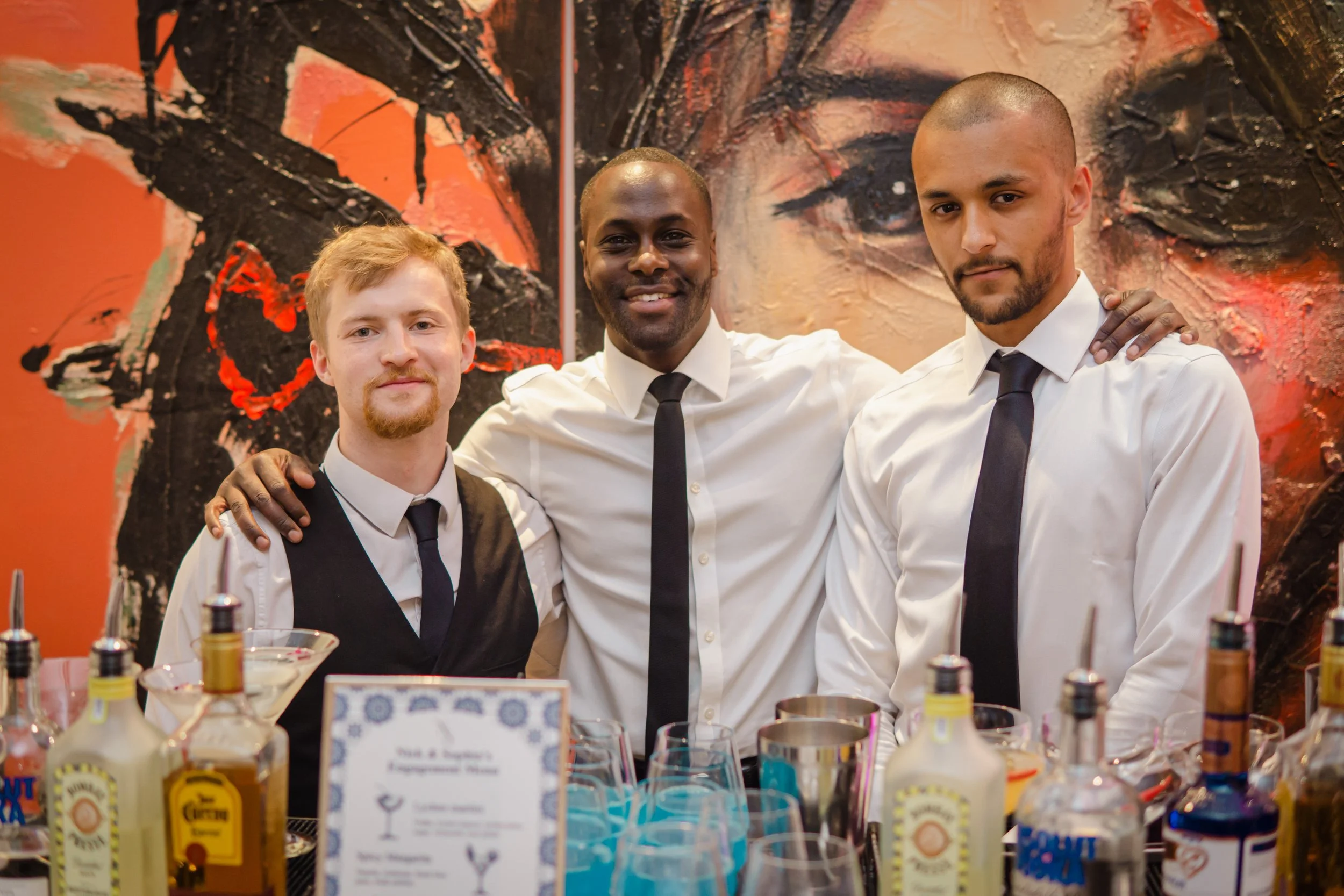 Private bartender preparing an organised cocktail bar before guests arrive at a private event.