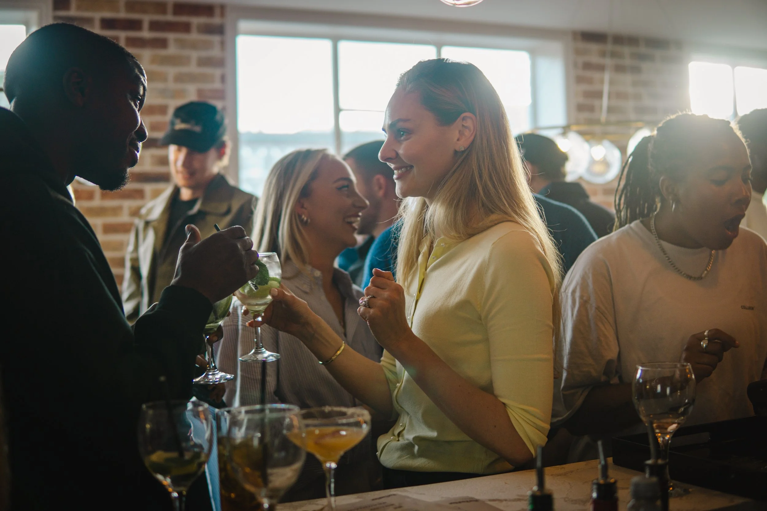 Corporate mixologist providing friendly personalised service at a London business event.
