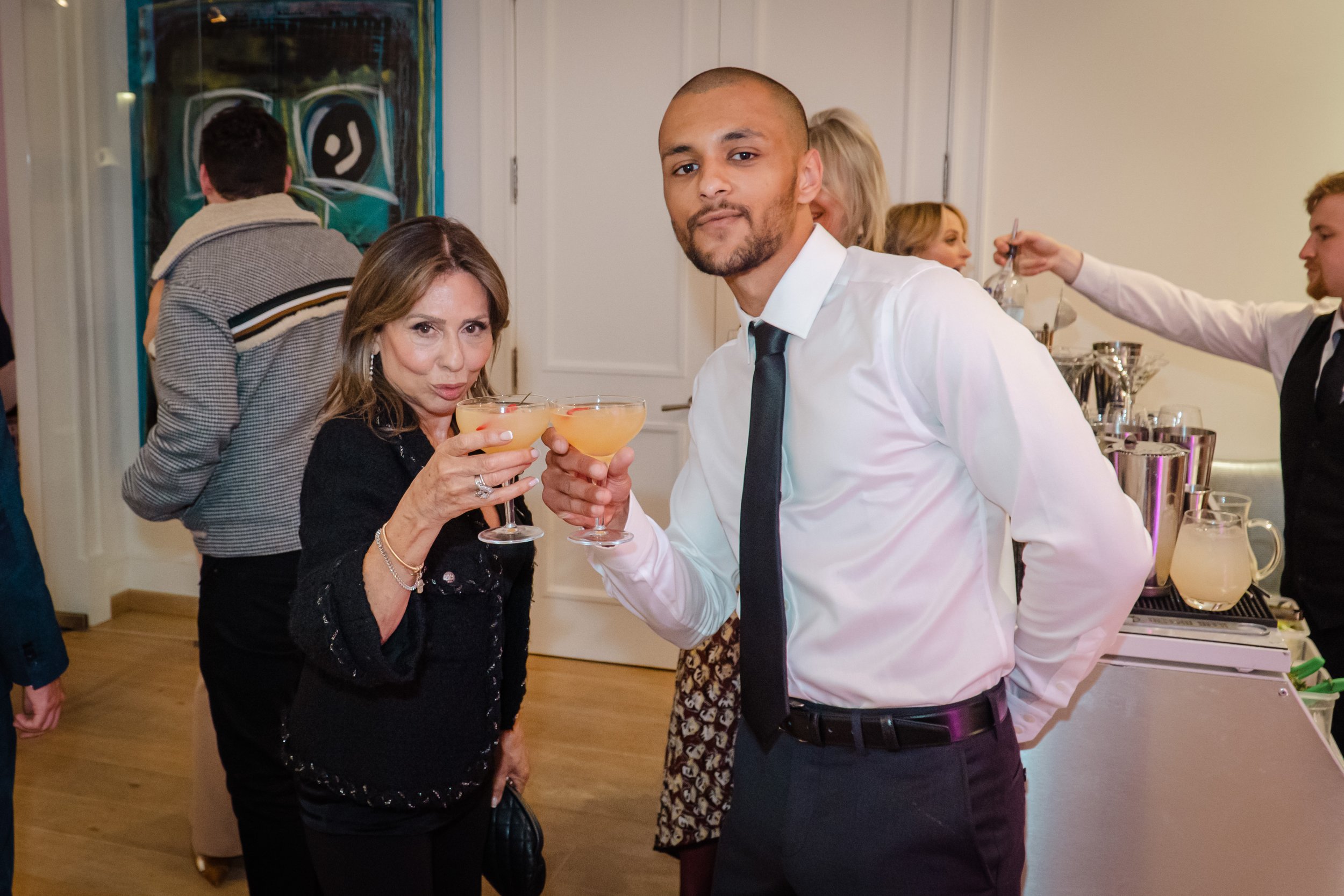 Private bartender staying calm and welcoming during a busy private party cocktail service.