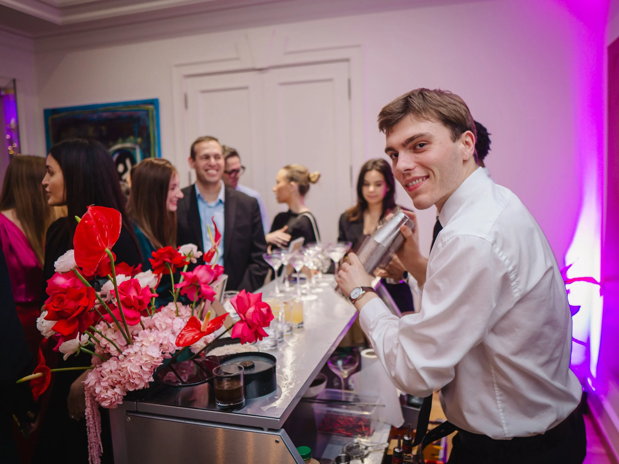 Luxury home cocktail bar experience with private mixologist serving guests in London.