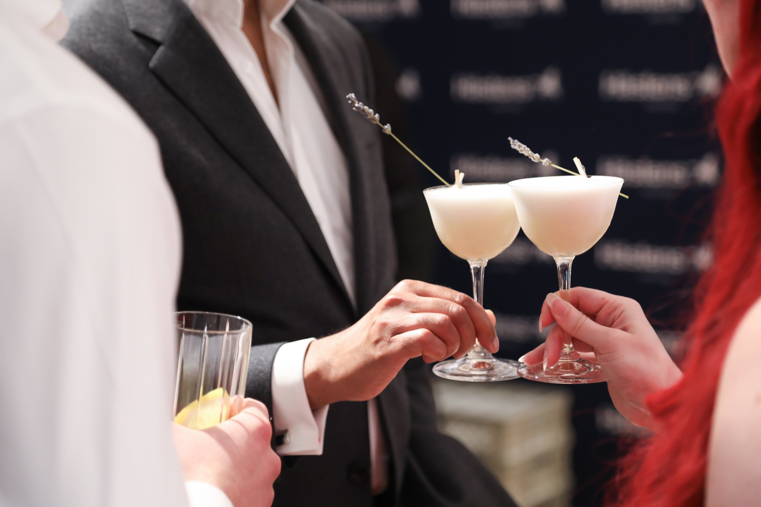 VIP stakeholders toasting with luxury cocktails at corporate event in London.