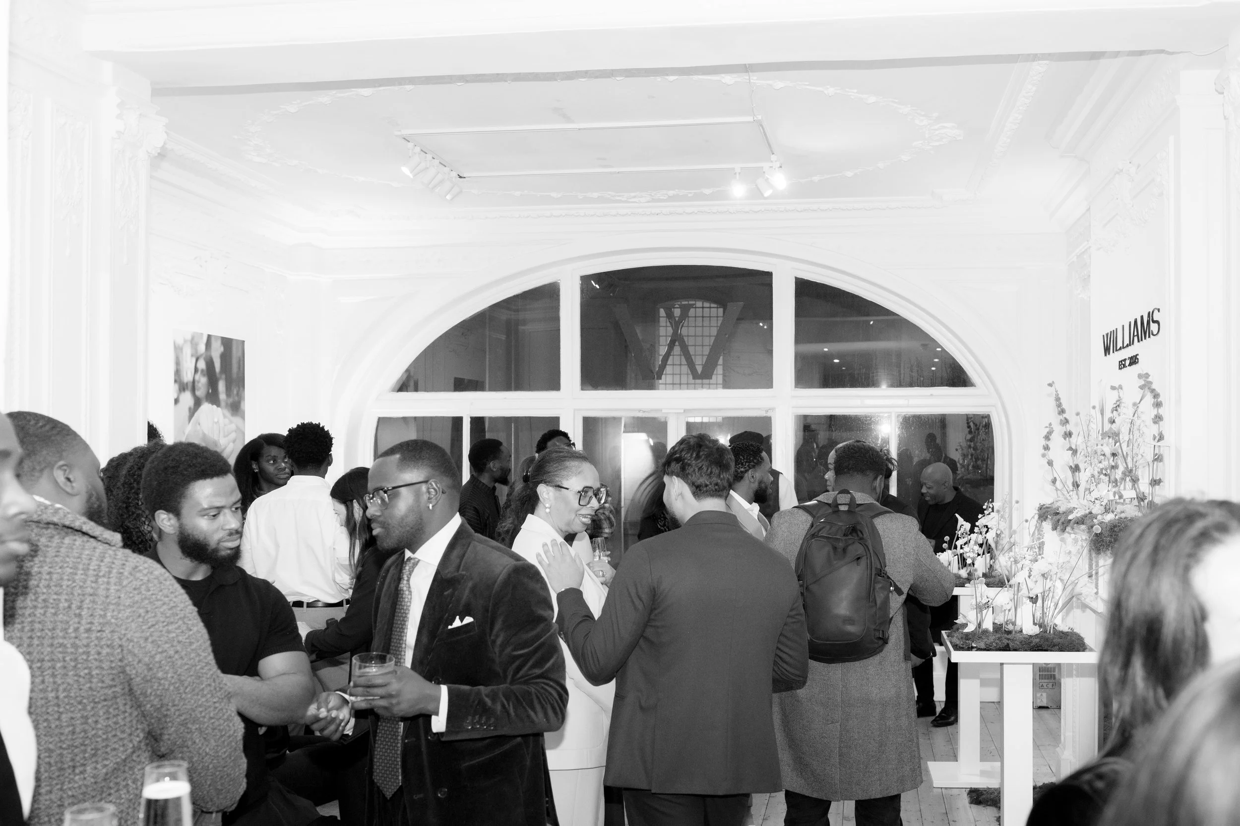 Corporate mixologist delivering warm and professional hospitality at a modern London business event.