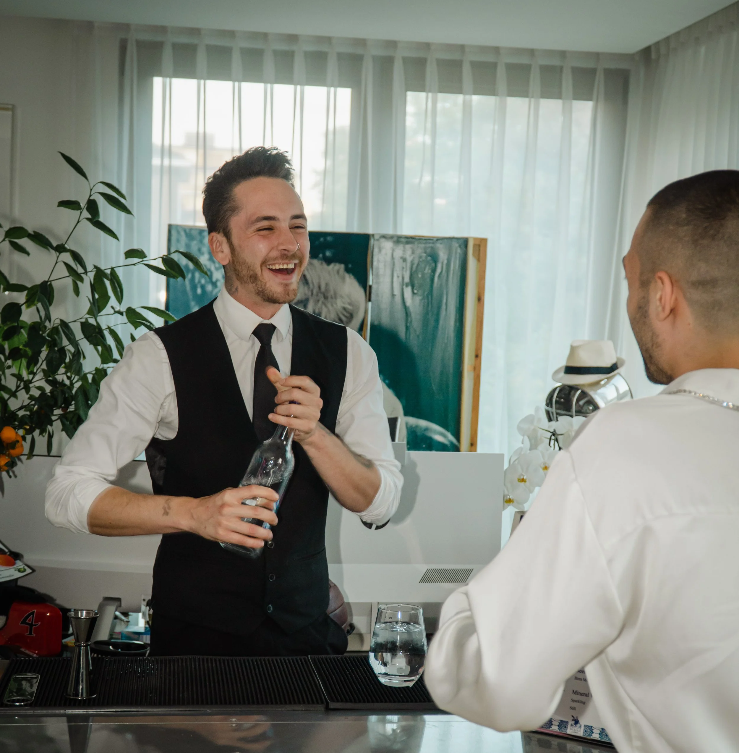 Friendly bartender for private event London creating welcoming atmosphere at house party.