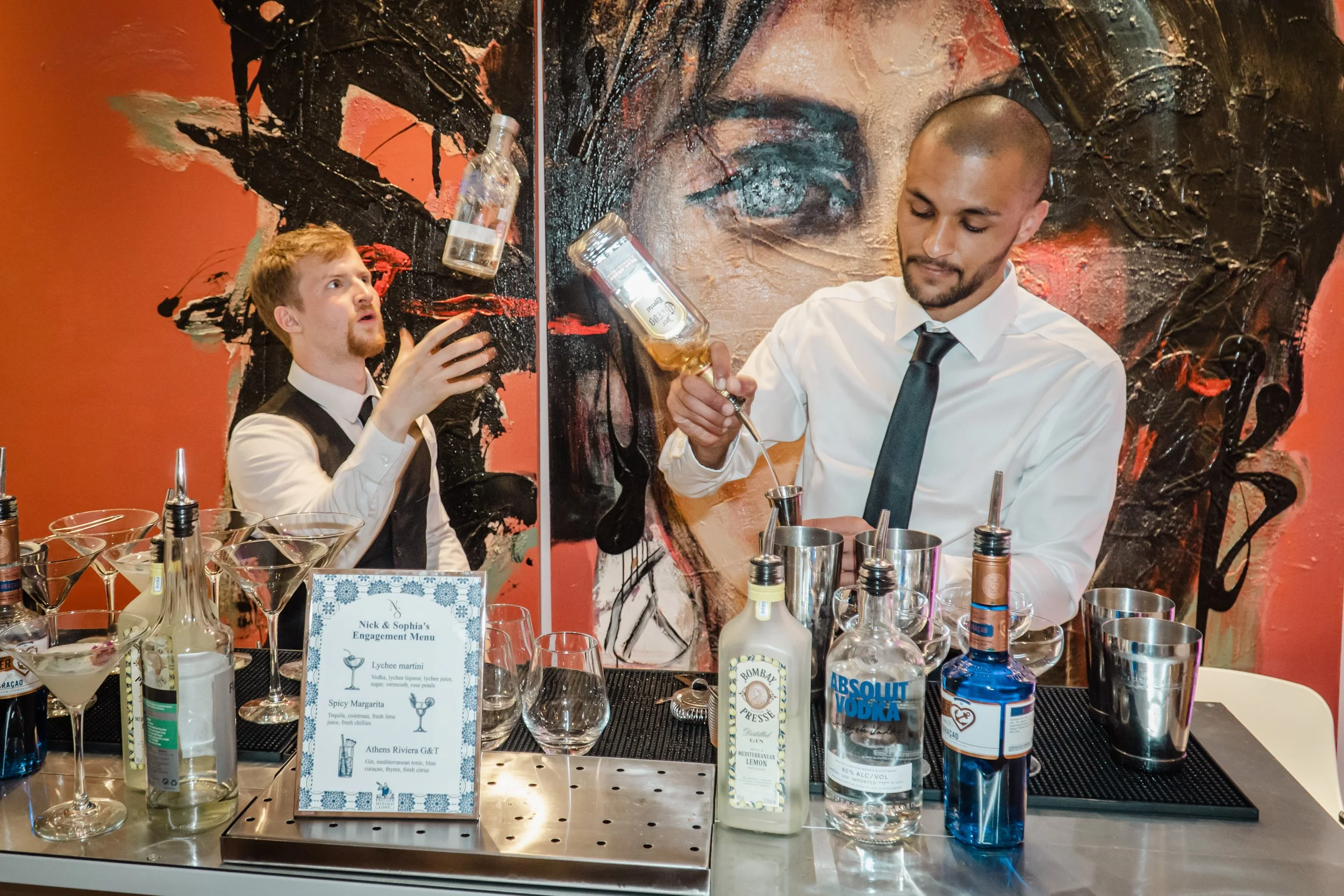 Private mixologist performing show-style cocktail preparation at a premium house party.
