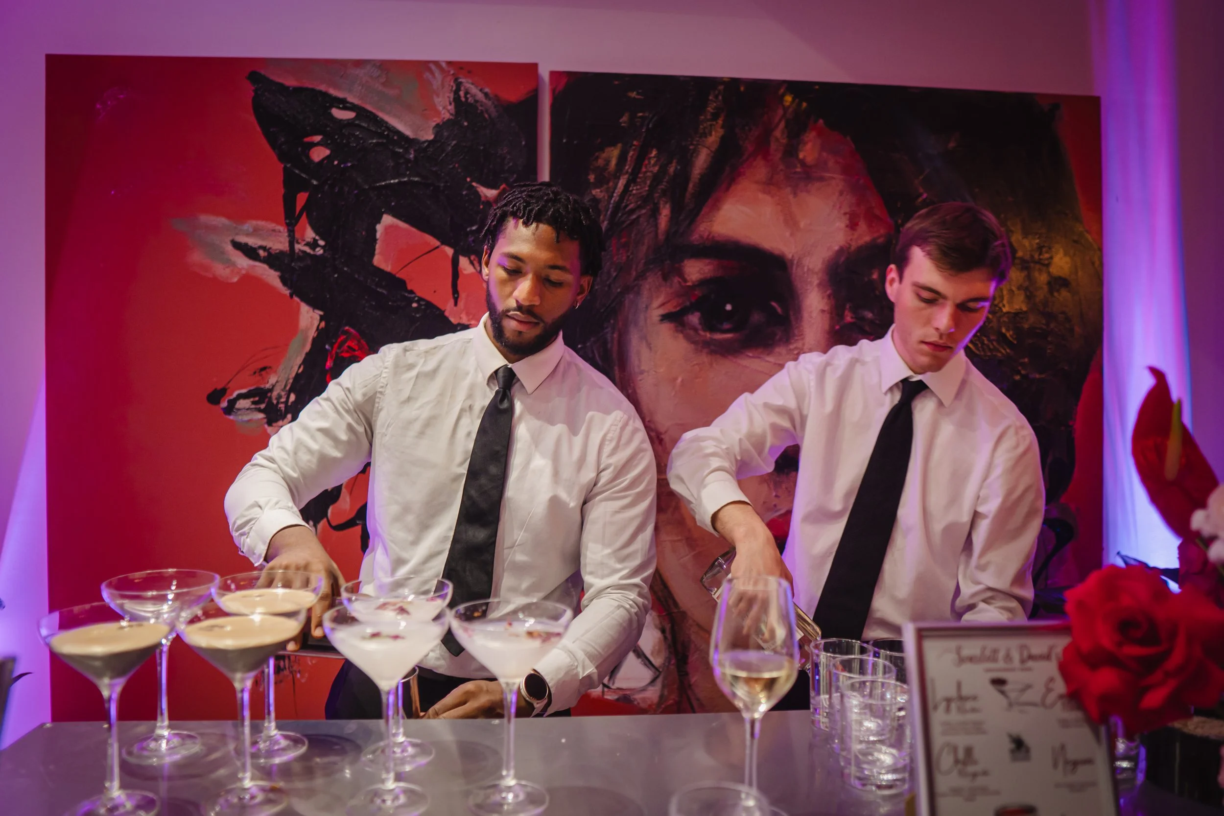 Hire a mixologist London service preparing elegant cocktail bar before private event begins.