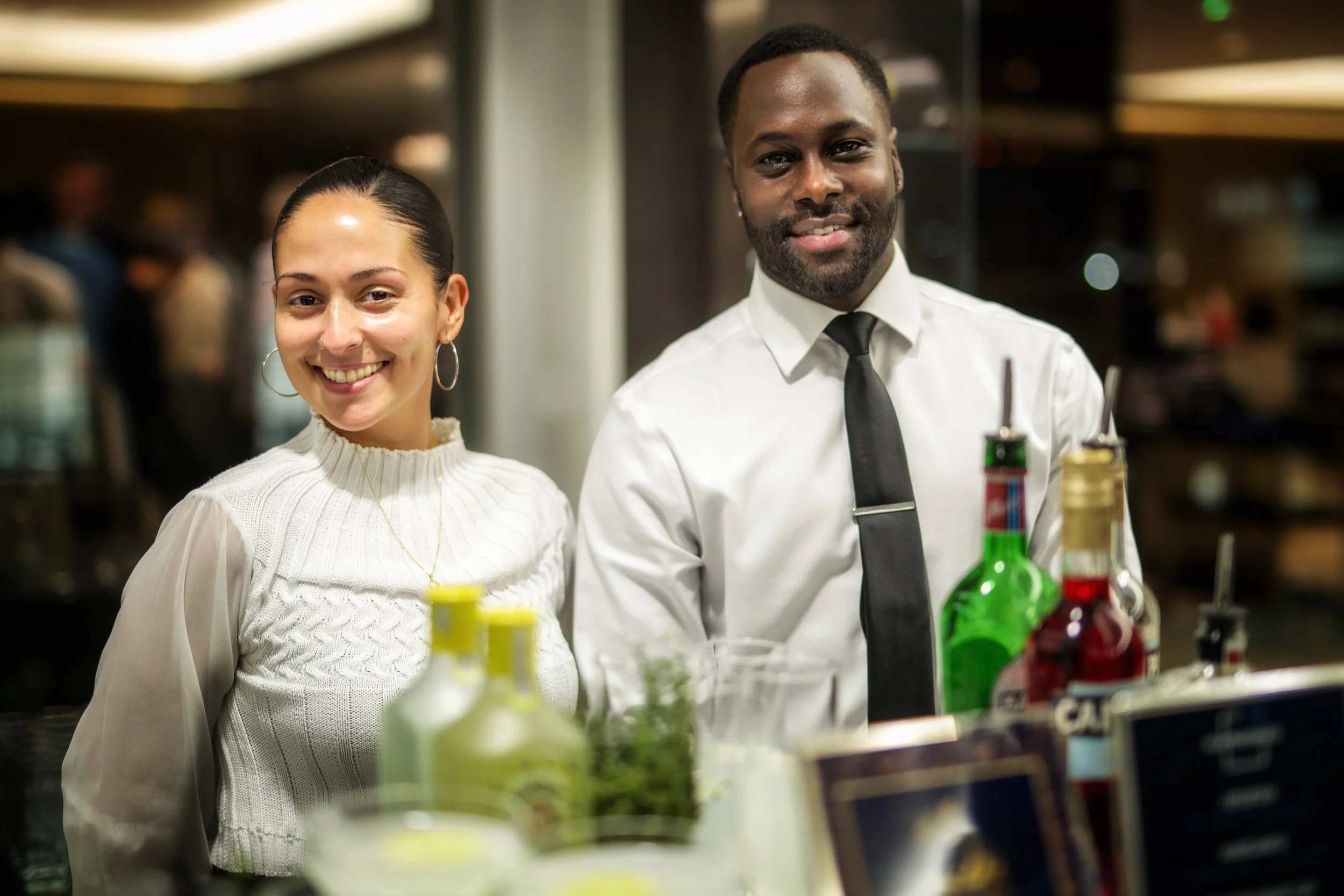 Luxury product launch event in London featuring a branded cocktail station and corporate mixologist.