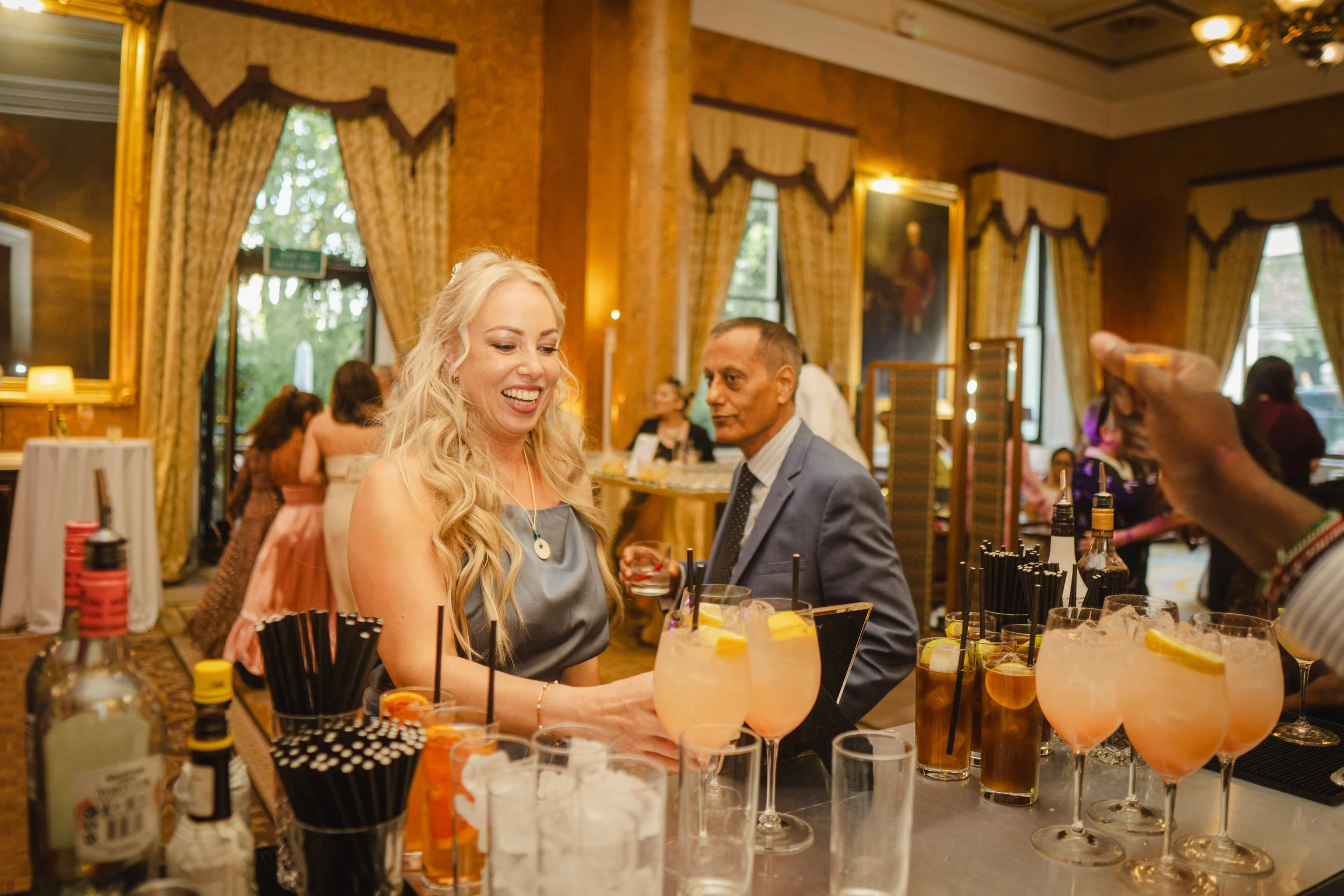 Wedding guests enjoying signature cocktails at a luxury cocktail bar during an evening reception in London.