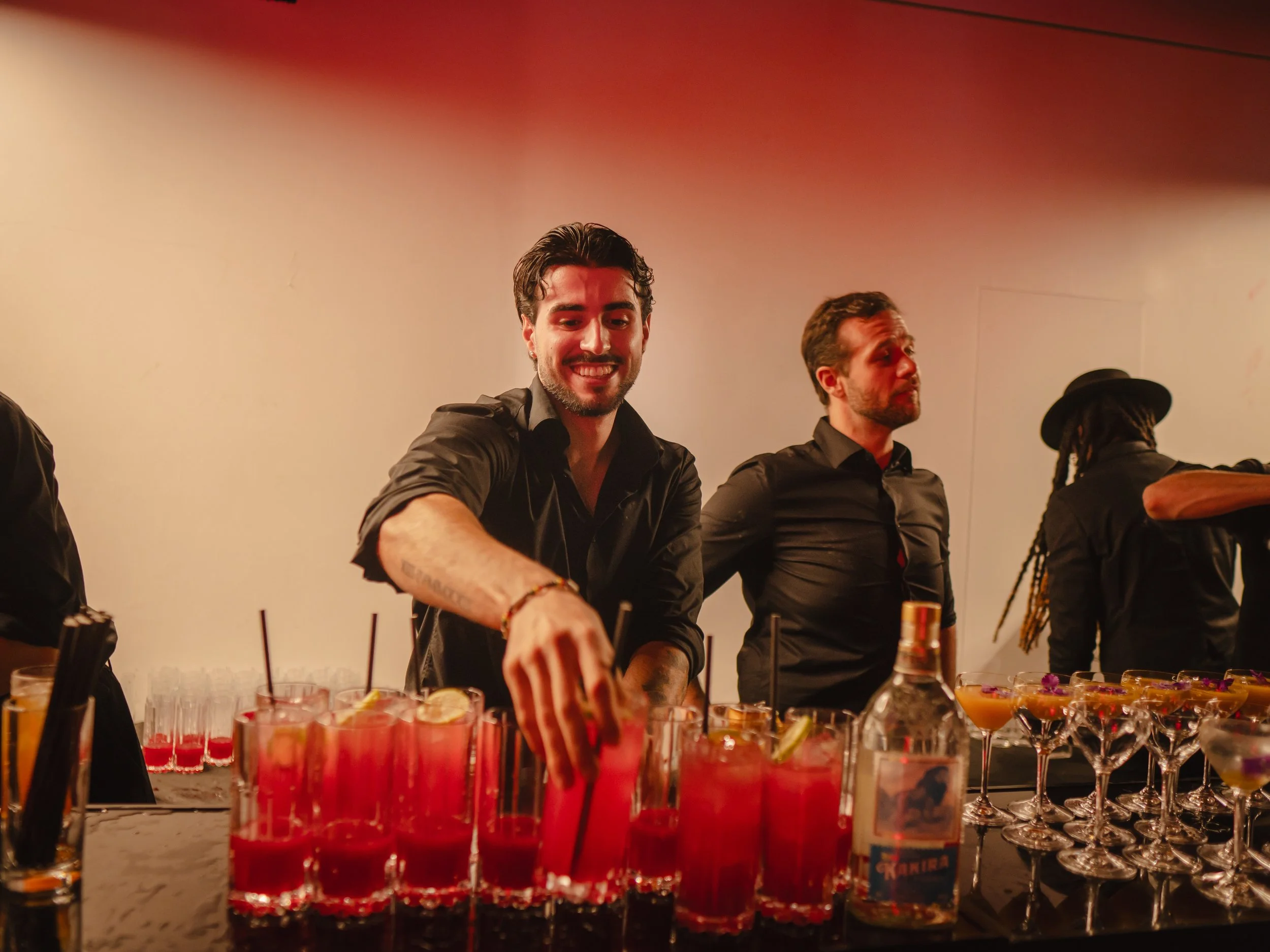 Corporate mixologist crafting premium cocktail at luxury cocktail bar for corporate events.