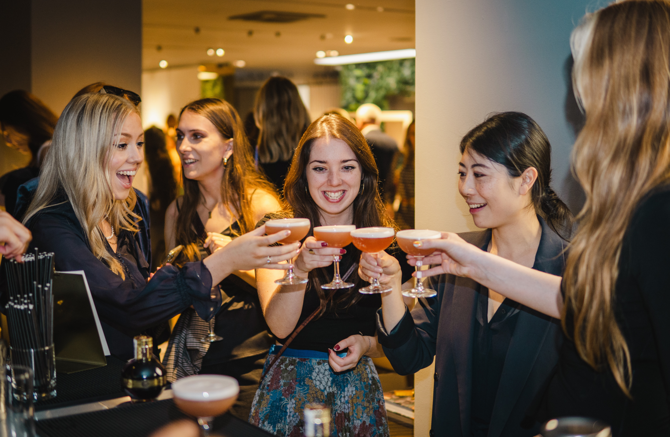 Employees celebrating with luxury cocktails at corporate Christmas party in London.