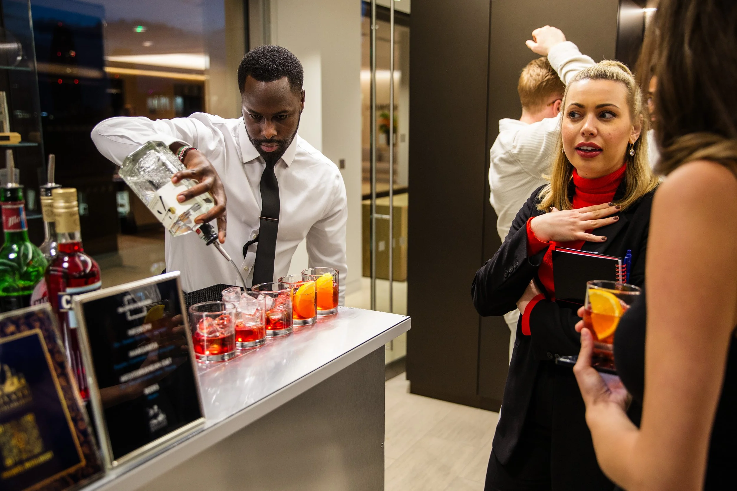 Corporate mixologist preparing an organised cocktail bar before a London corporate event begins.