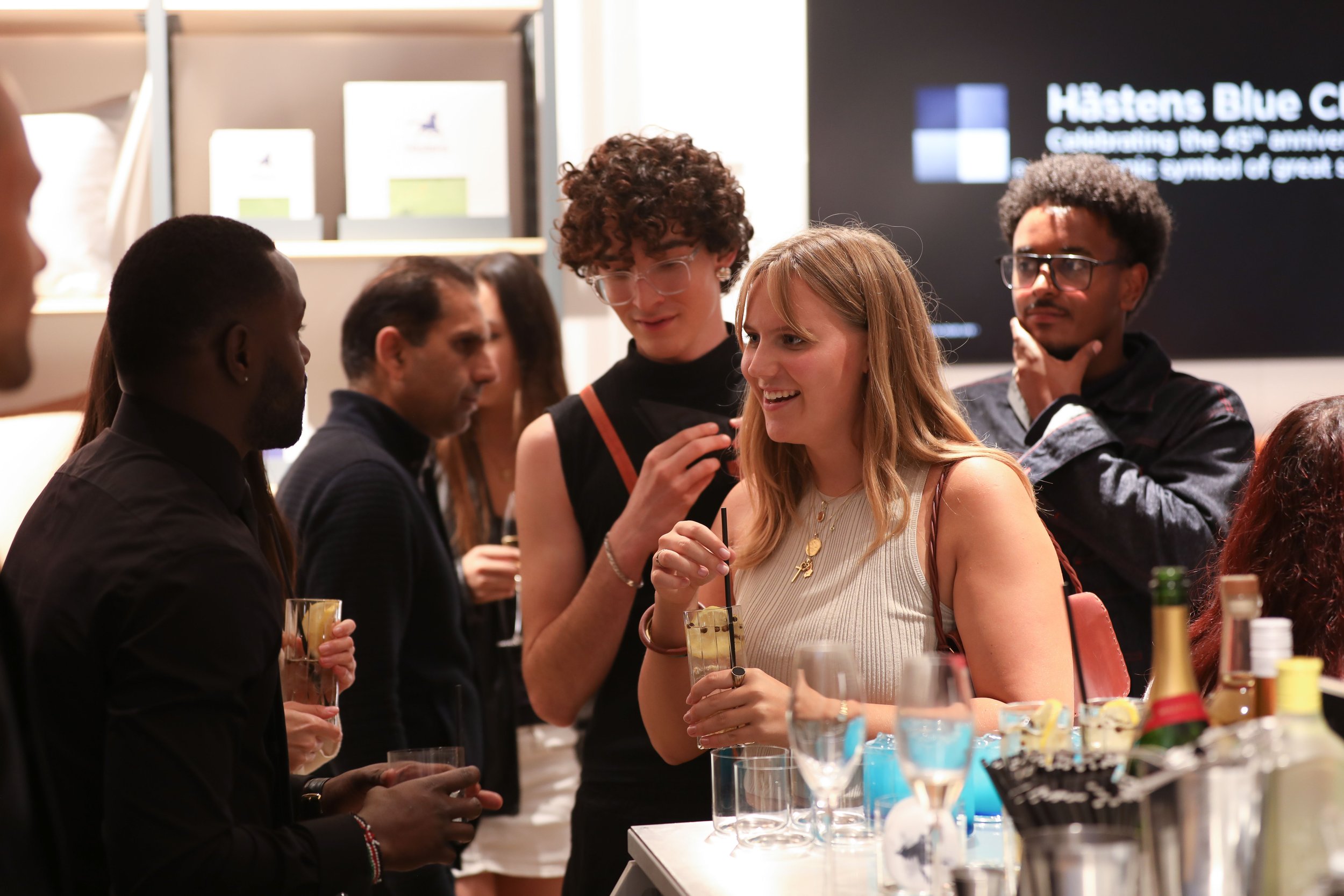 Corporate mixologist welcoming guests with personalised recommendations at a premium London event.