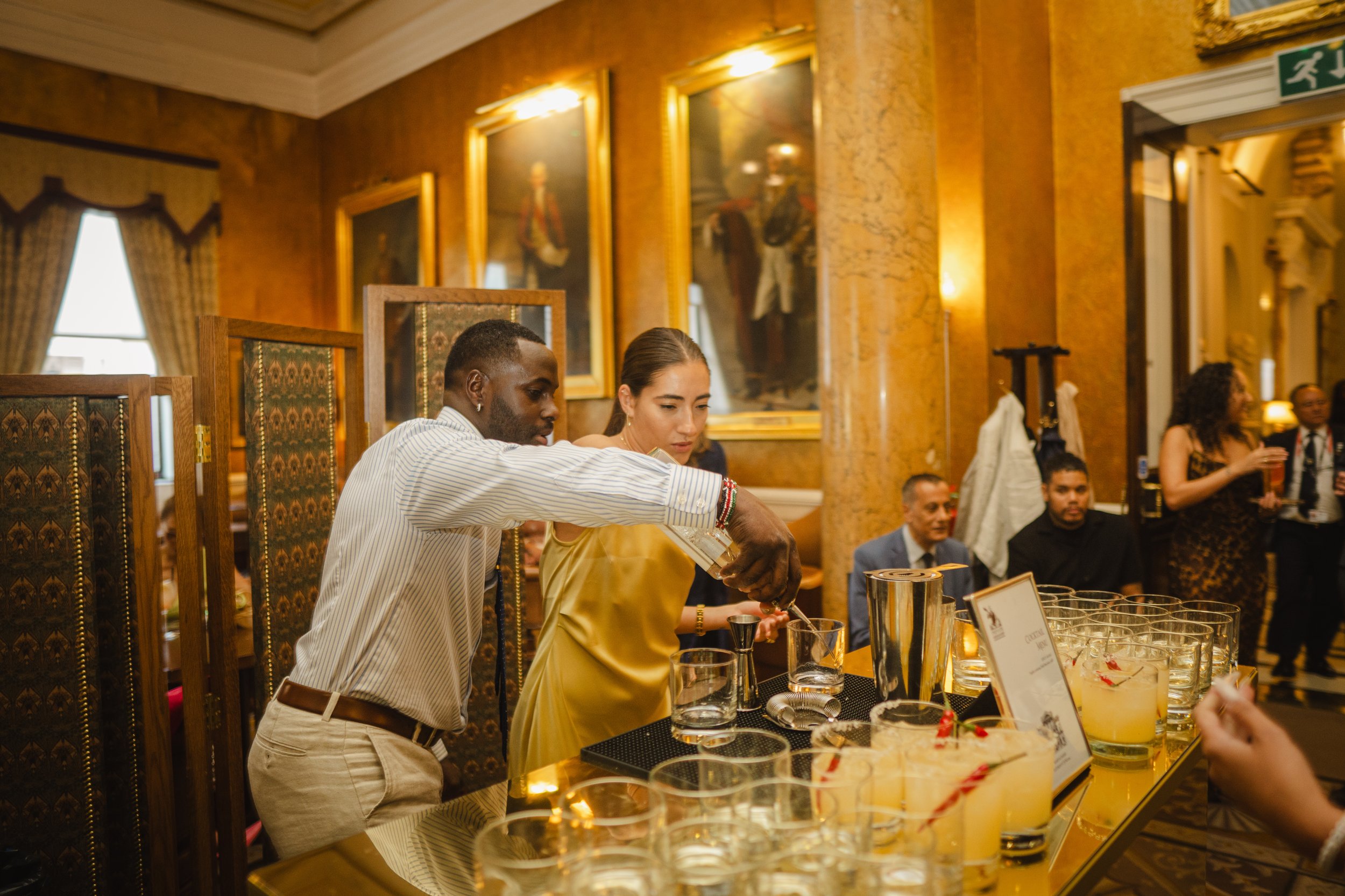 Wedding mixologist creating signature evening cocktails at luxury wedding reception