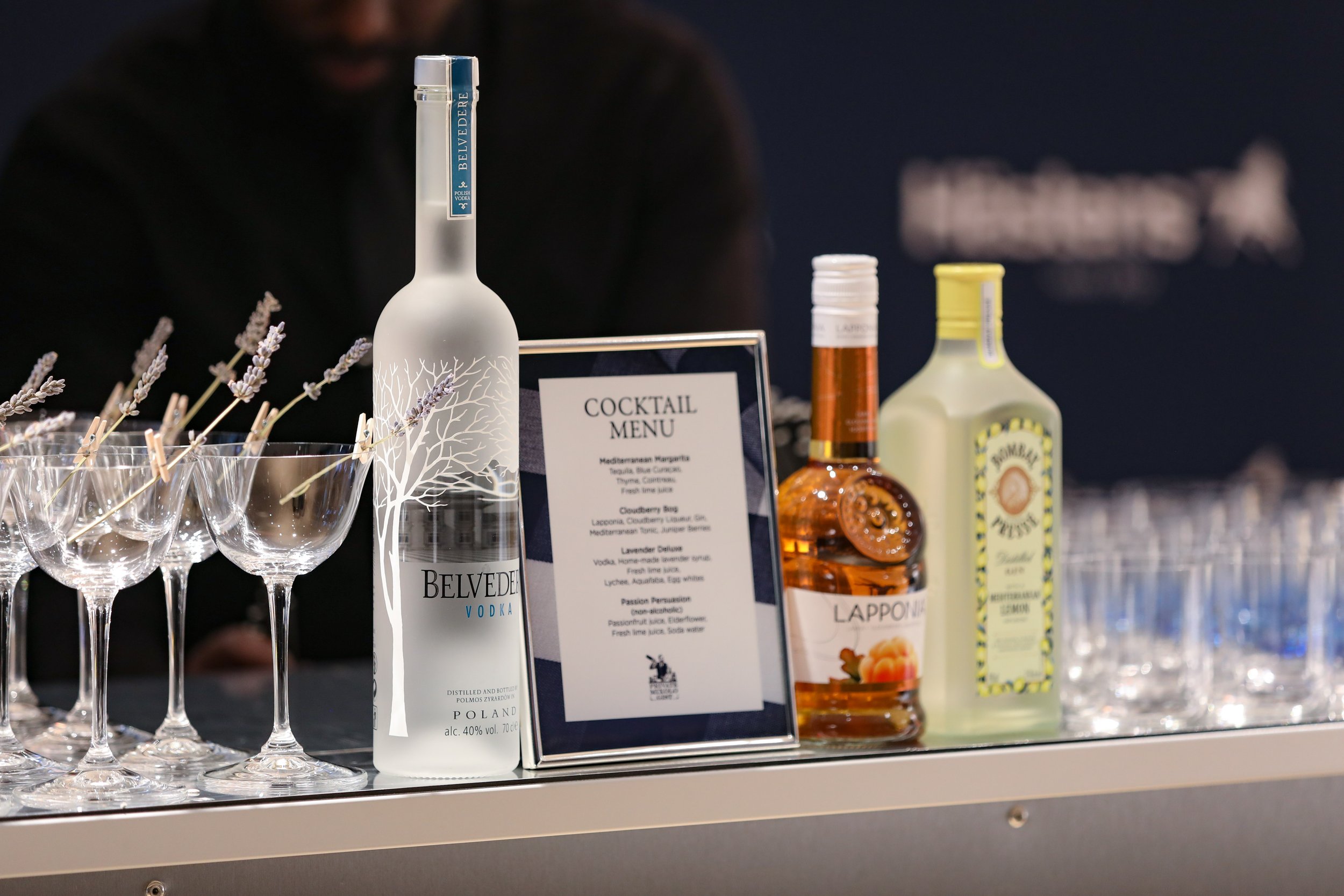 Branded cocktail menu and luxury cocktail bar at corporate product launch event.