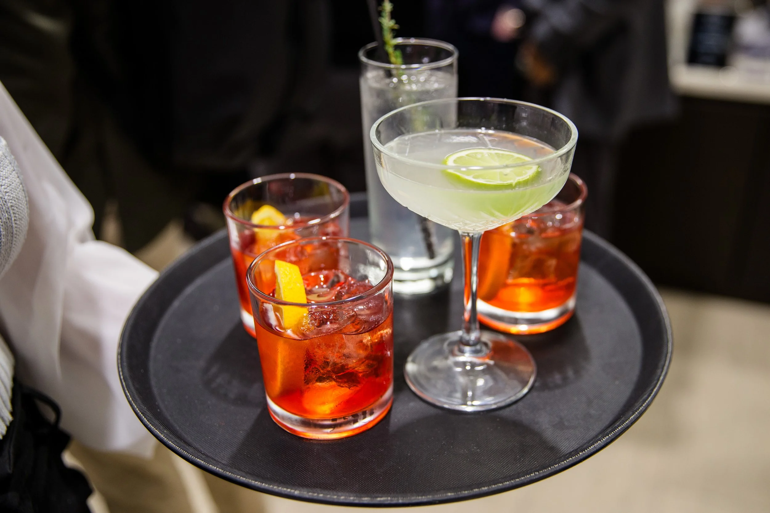 Luxury midnight cocktail toast prepared by private bartender at New Year’s Eve house party.