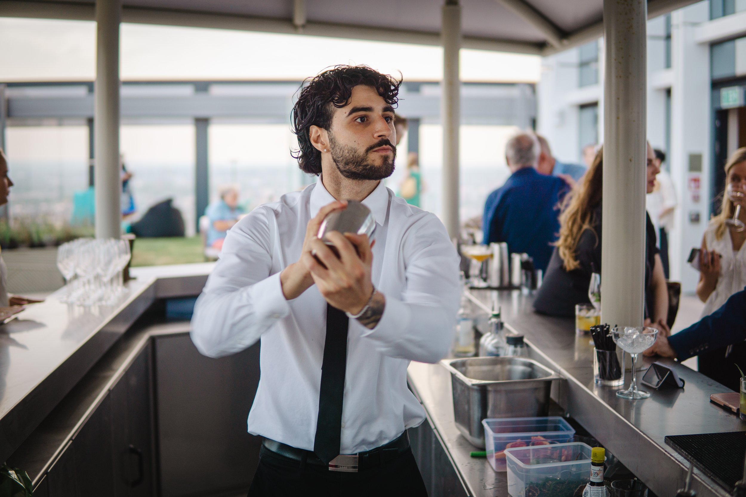 Corporate mixologist performing live cocktail preparation at networking event