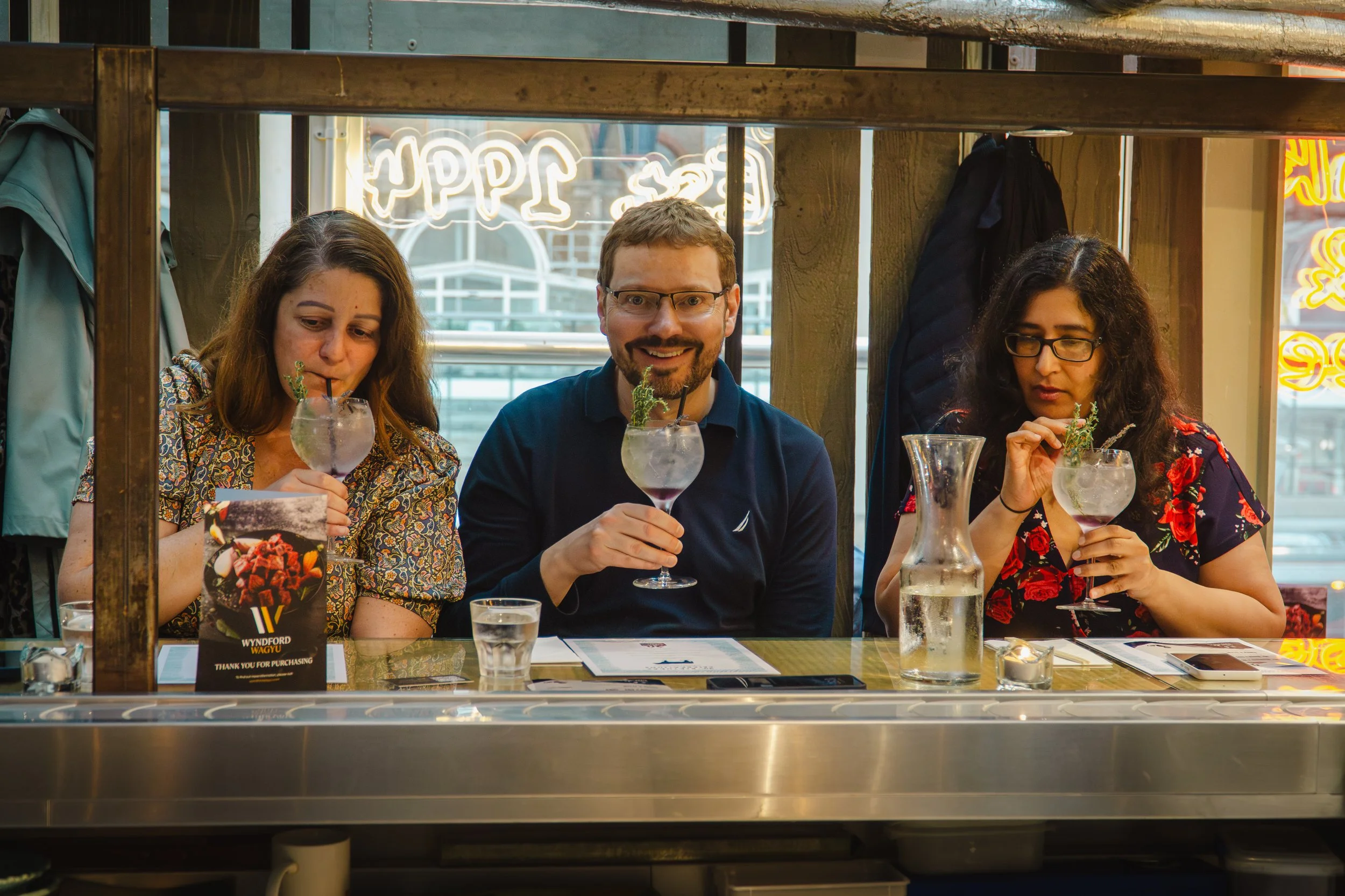 Guests enjoying premium cocktails at a luxury house party with private mixologist.