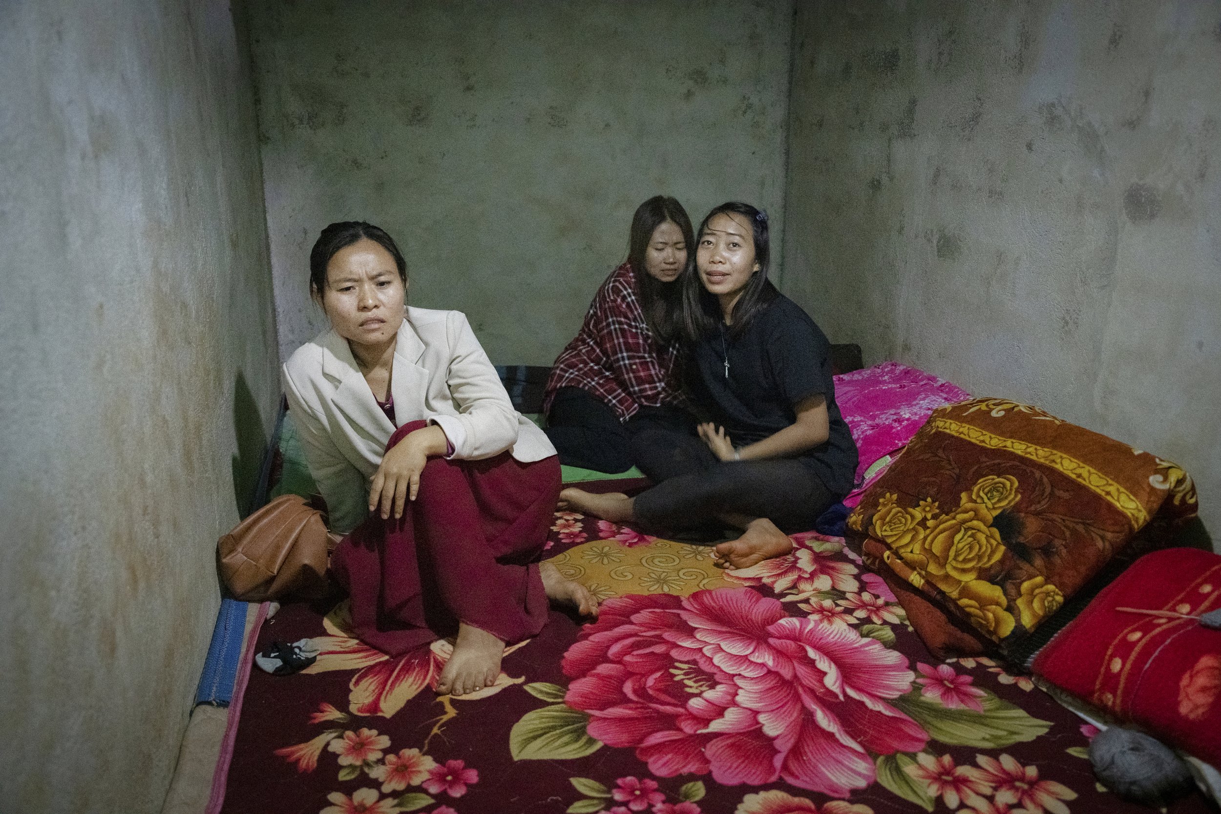 Nurses scream in fear while hiding in a bomb shelter during an attack by fighter jets of the government army. Demoso, Myanmar, 2023