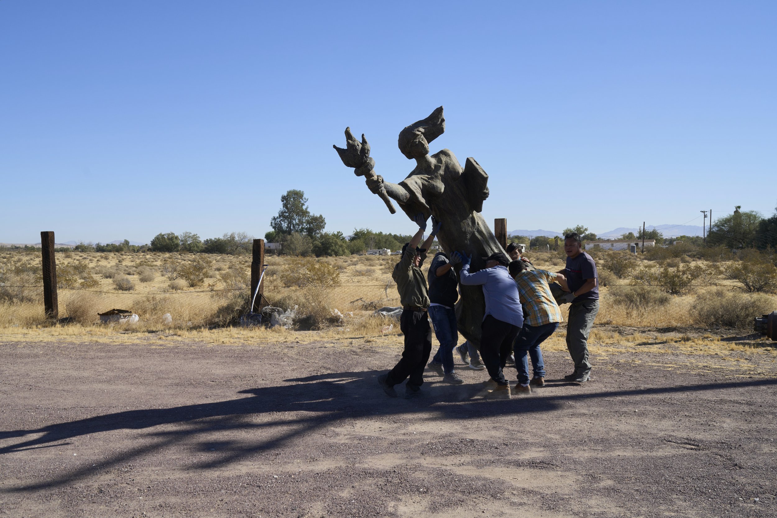 Chinese dissidents carrying statue of Goddess of Democracy. California, USA, 2020