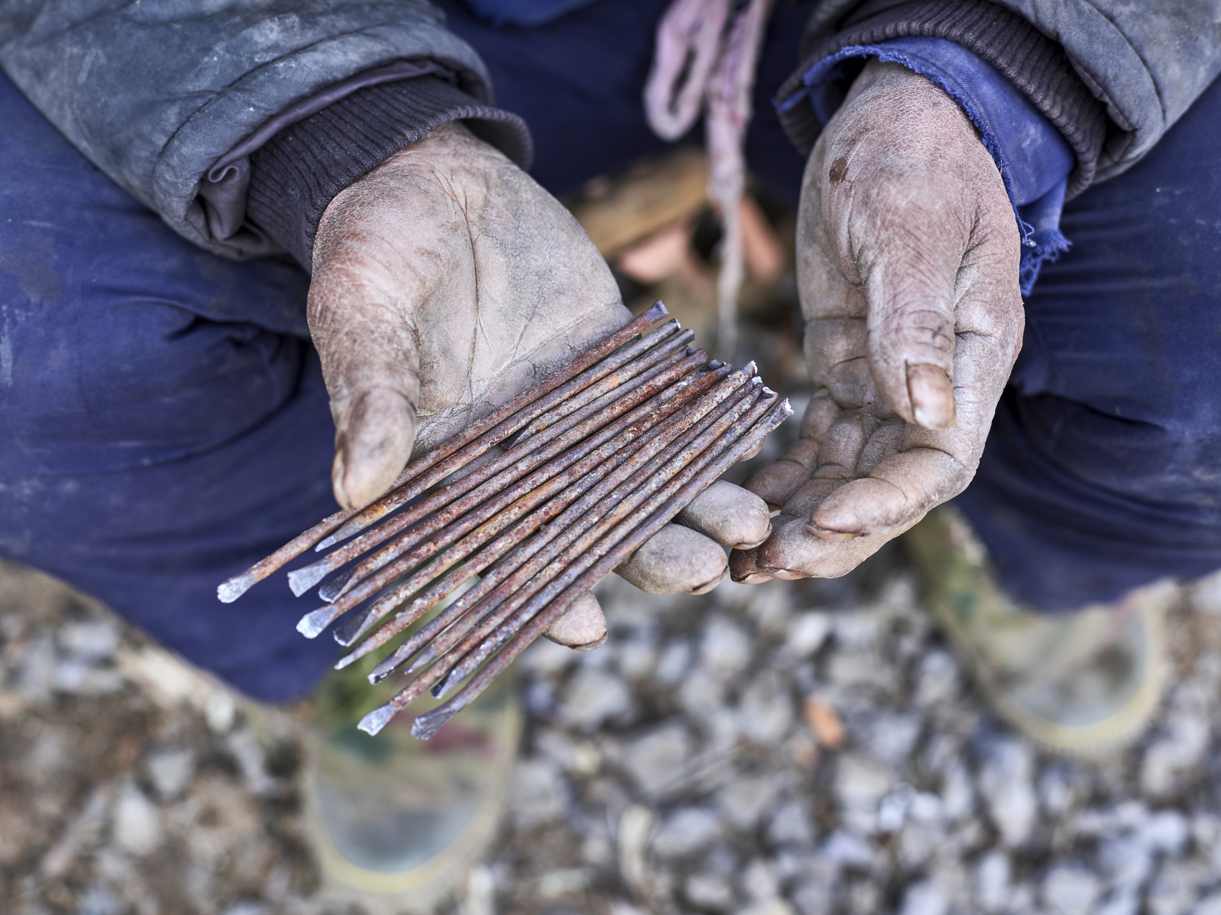 Hu Guangzhou holding improvised iron nails for his tower. Shandong, China, 2016