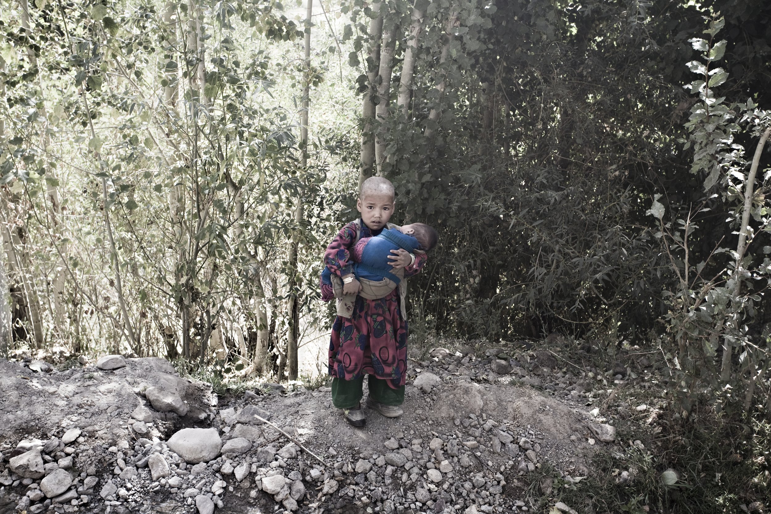 Girl holding baby. Ghor, Afghanistan, 2008