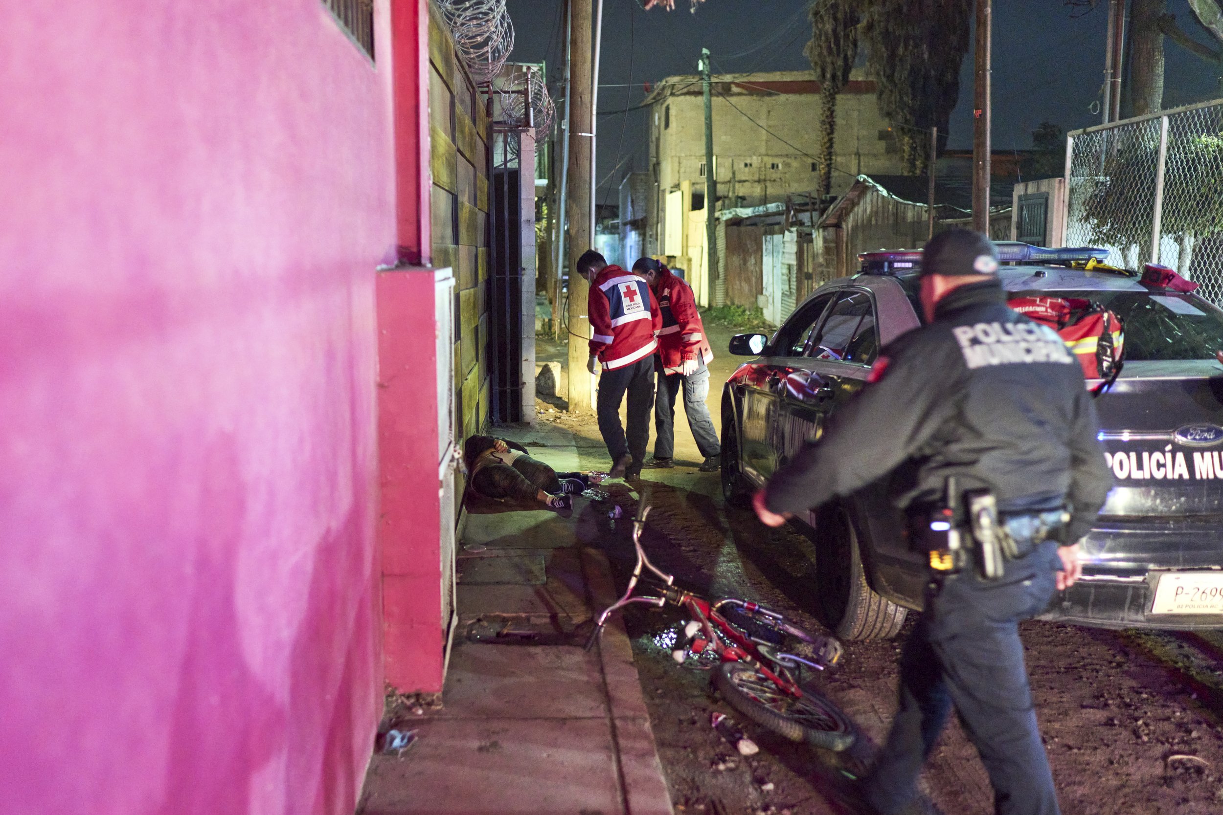 First aid team attending crime scene where drug runner was liquidated. Tijuana, Mexico, 2021