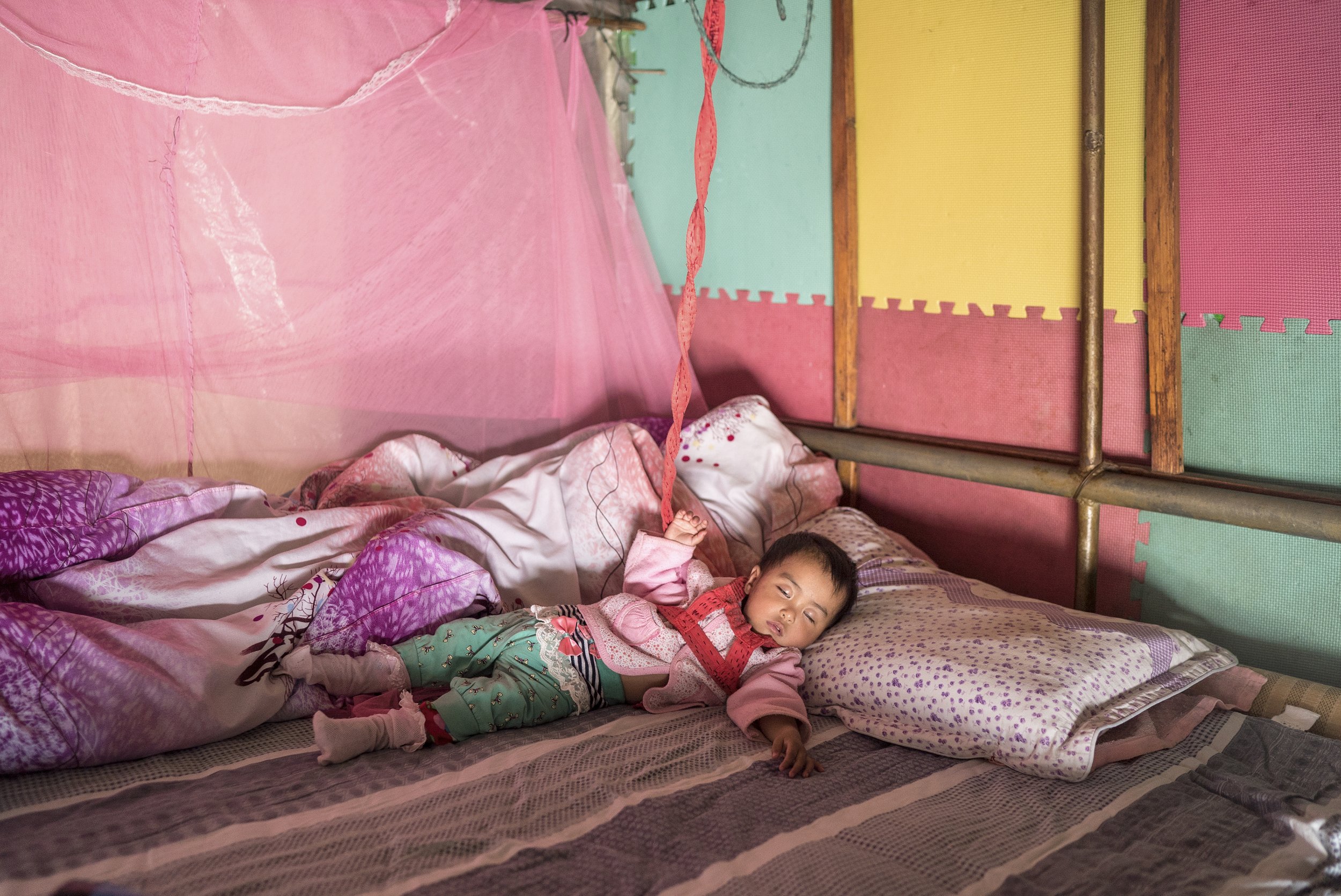 Child sleeping on fishing boat. Hong Hu, China, 2015