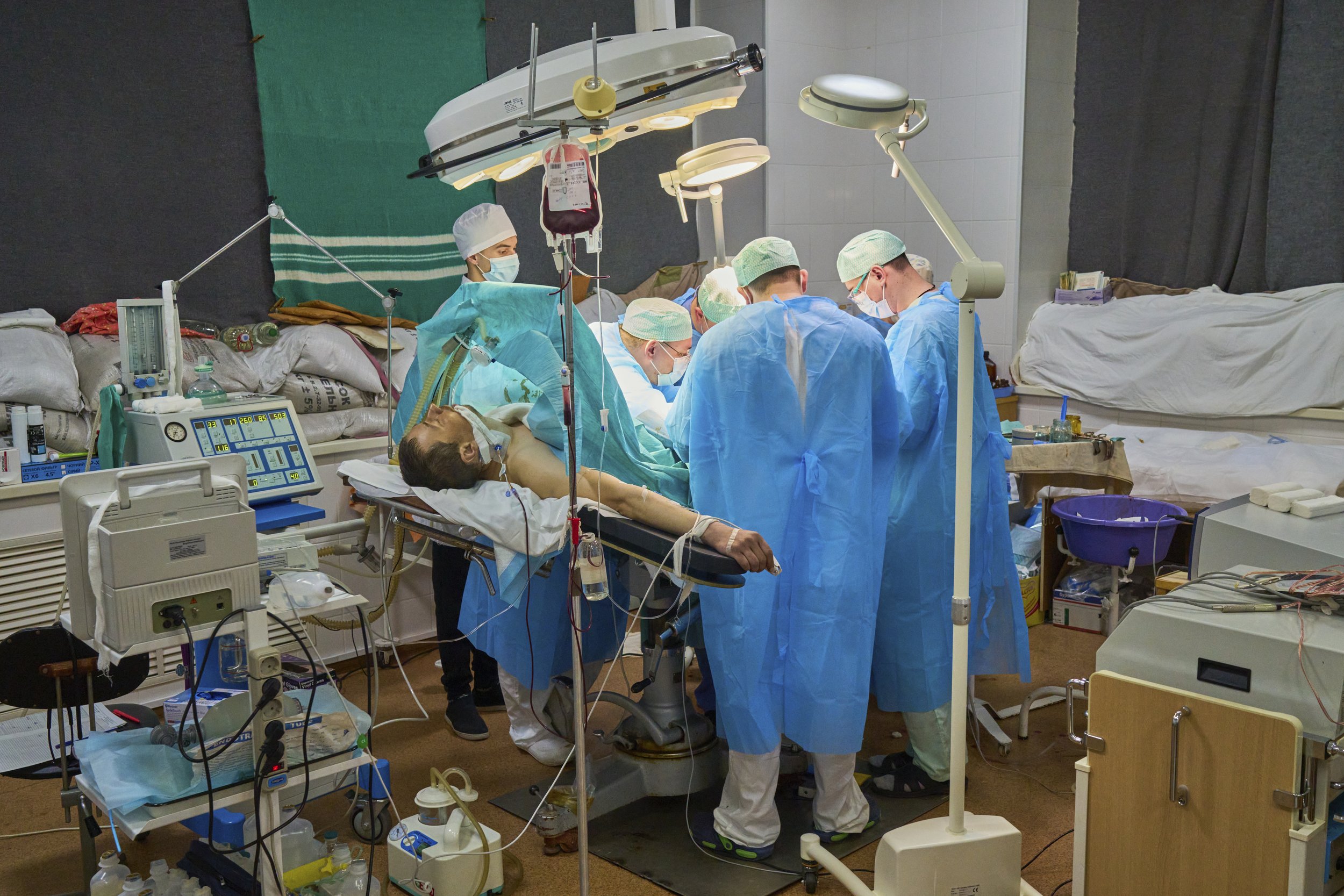 Doctors in a fortified operation theatre amputate the leg of Ukrainian soldier. Zaporizhzhia, Ukraine, 2022