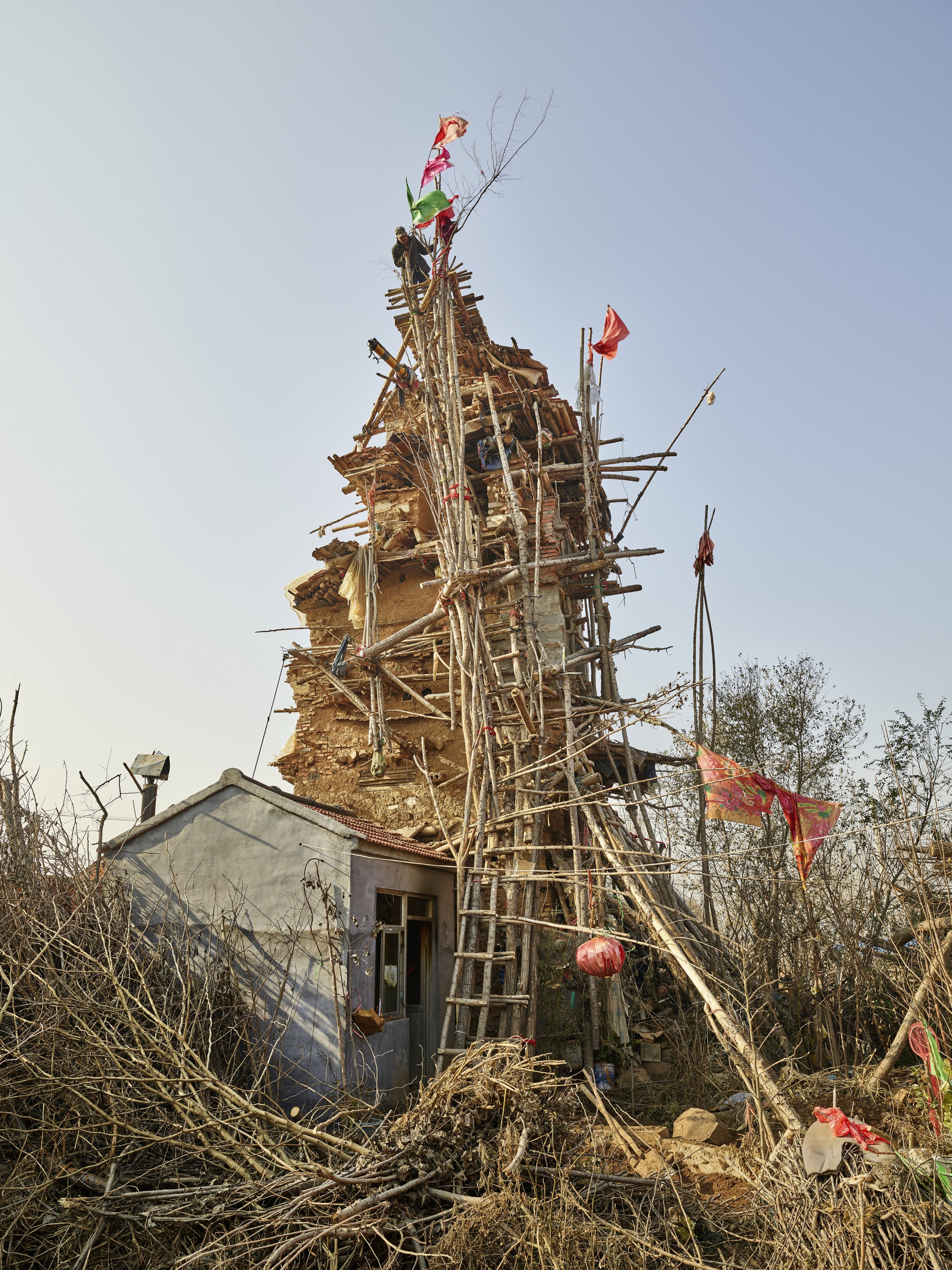 Man building tower to reach heaven and his deceased family. Shandong, China, 2016